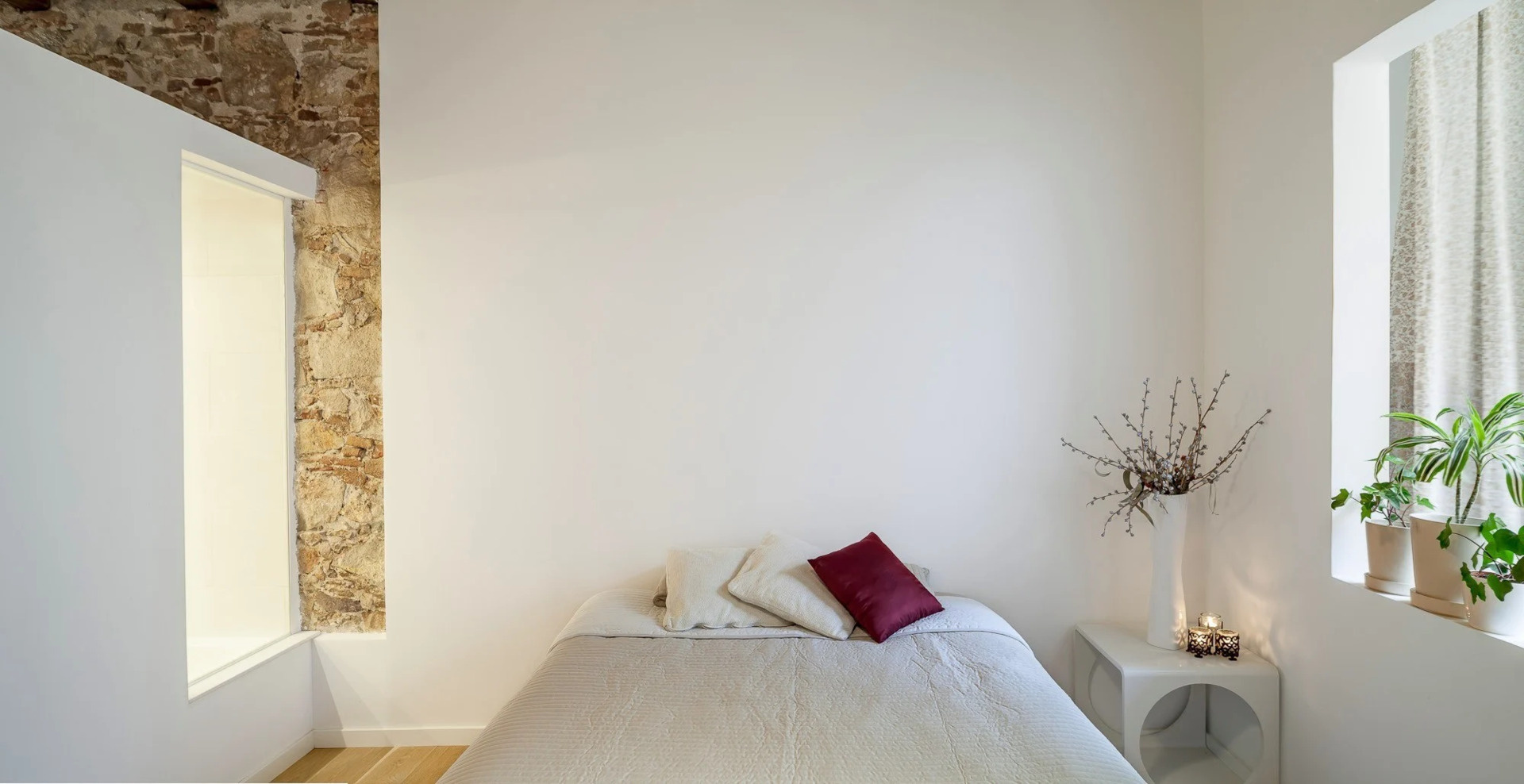 Elevated on a quiet platform, the bedroom offers a restful retreat defined by warm wood, soft light, and subtle transitions.