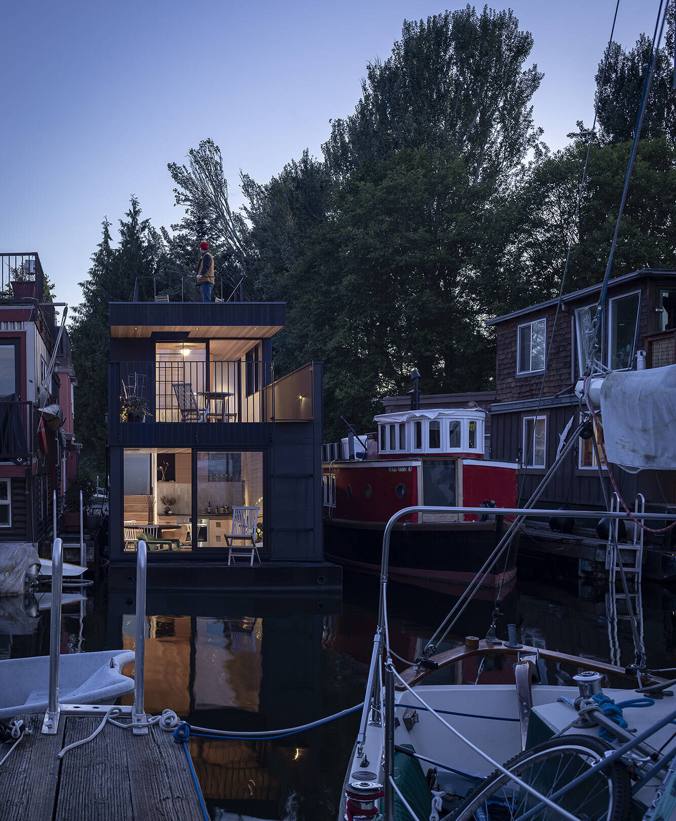 Vertical cedar siding, Richlite panels, and clear hemlock soffits give this floathome a refined, marine-ready exterior with architectural clarity.