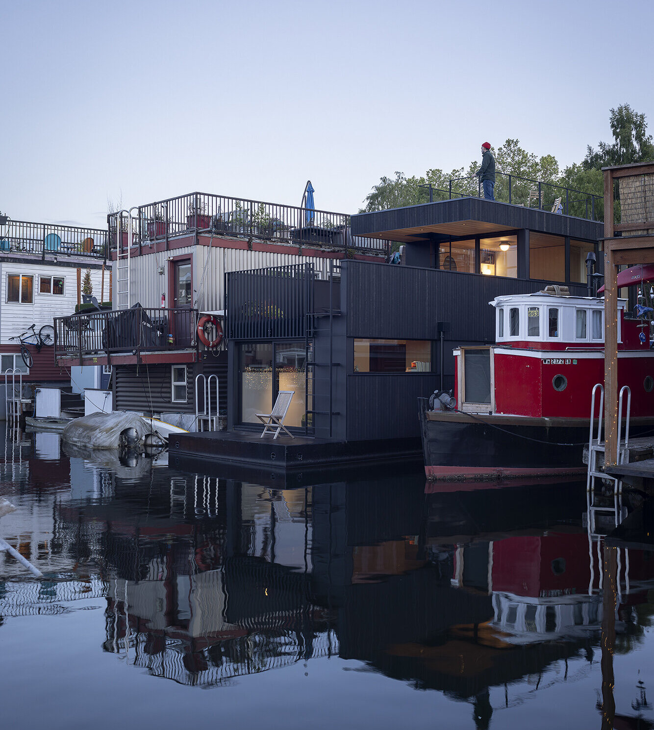 Vertical cedar siding, Richlite panels, and clear hemlock soffits give this floathome a refined, marine-ready exterior with architectural clarity.