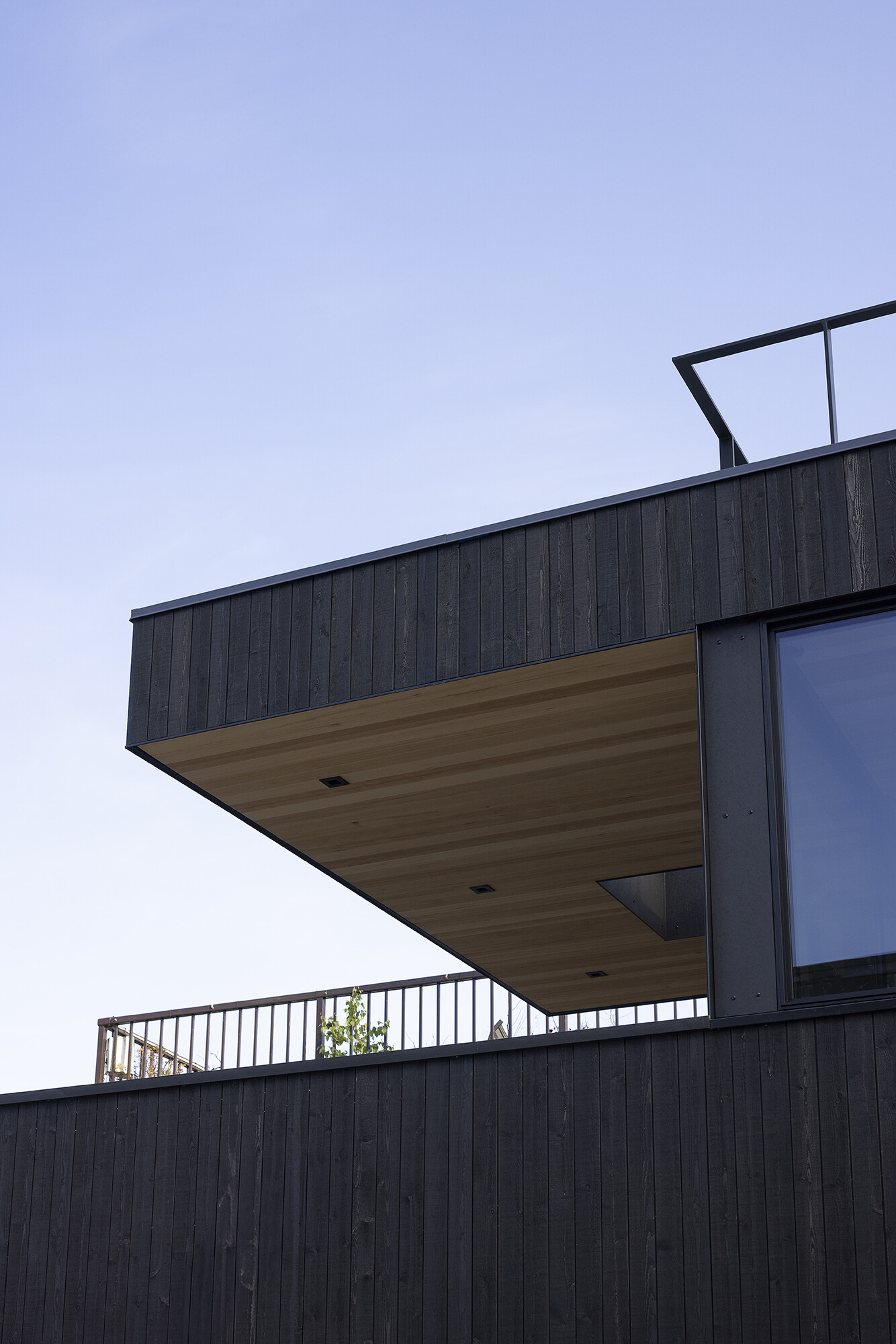 Vertical cedar siding, Richlite panels, and clear hemlock soffits give this floathome a refined, marine-ready exterior with architectural clarity.