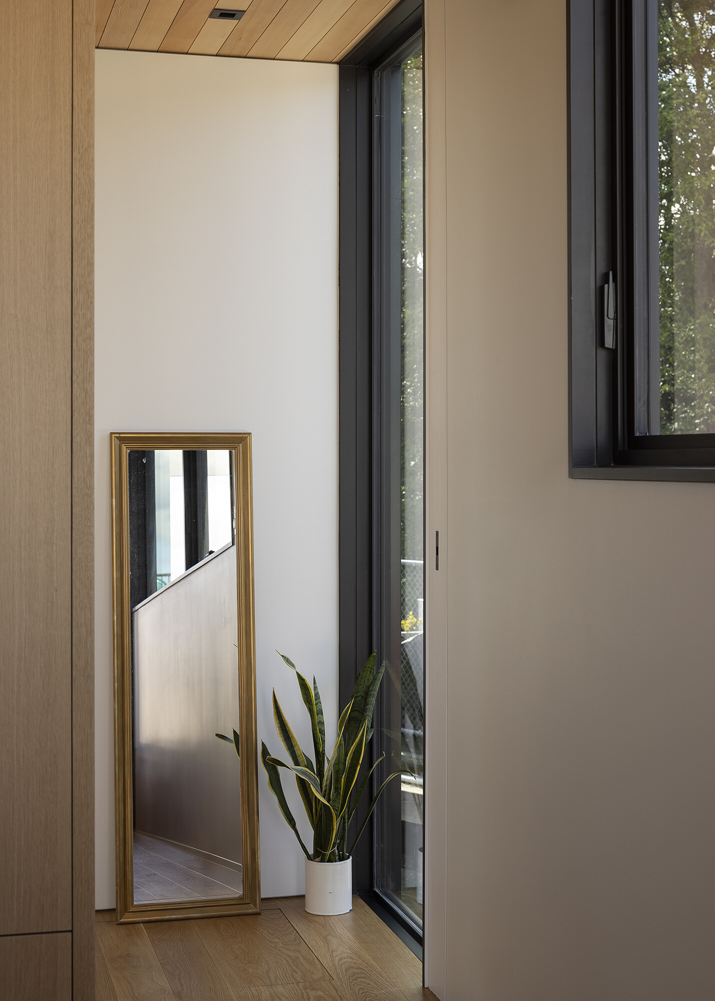 A space-saving stair anchors the floathome, wrapping the core to provide circulation and built-in storage above and below.