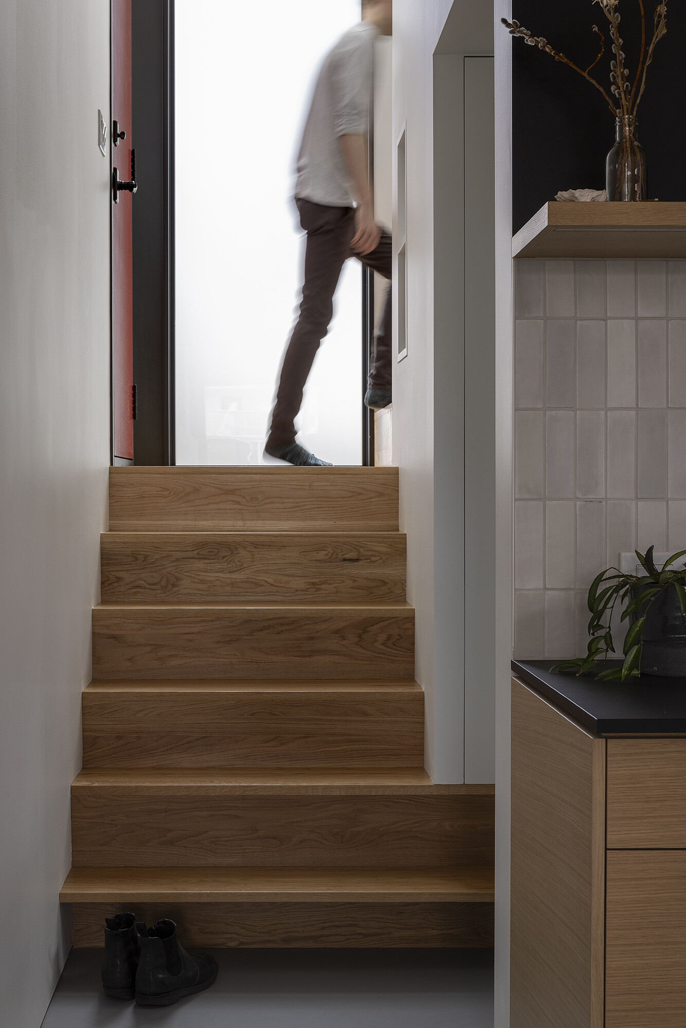 A space-saving stair anchors the floathome, wrapping the core to provide circulation and built-in storage above and below.