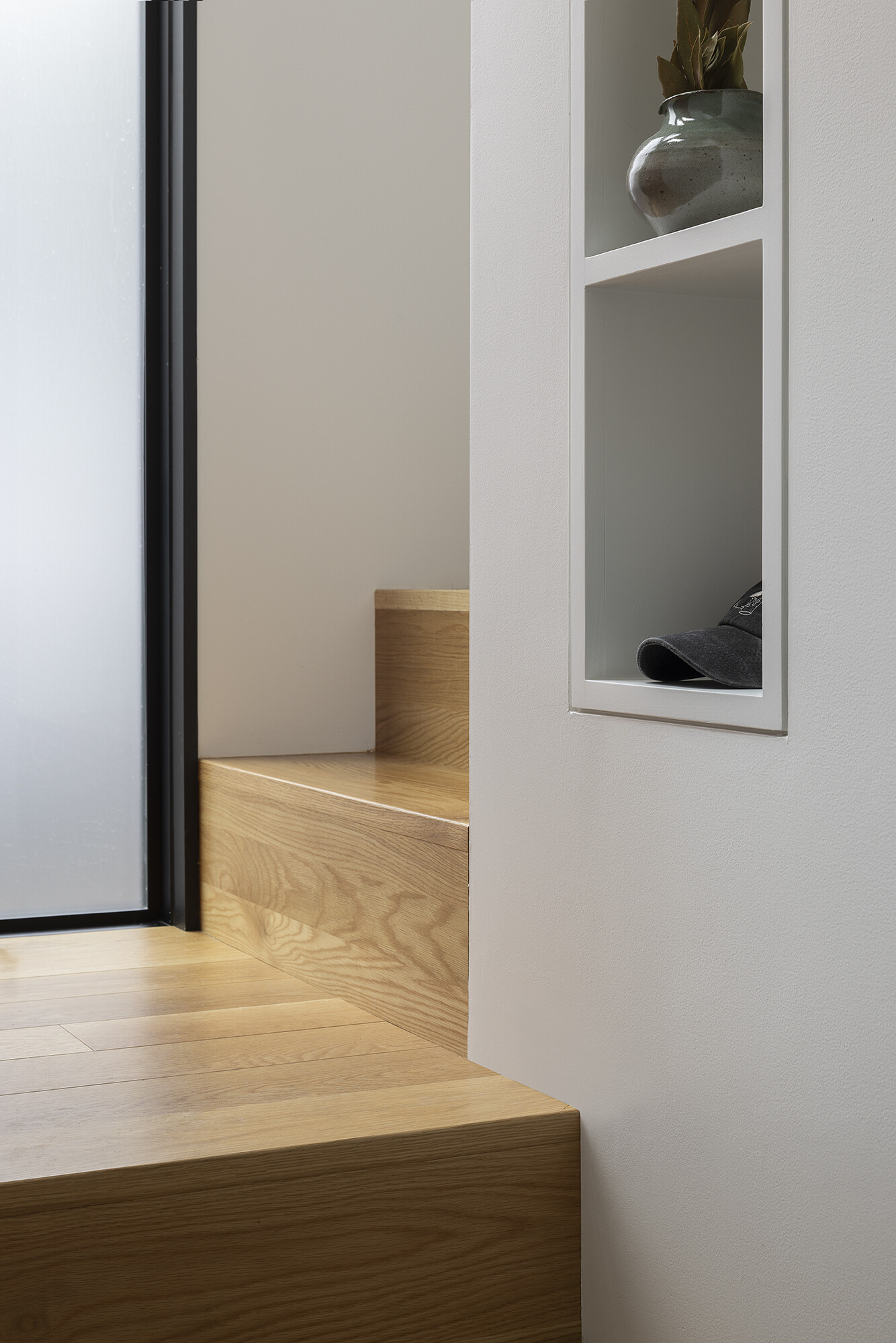 A space-saving stair anchors the floathome, wrapping the core to provide circulation and built-in storage above and below.