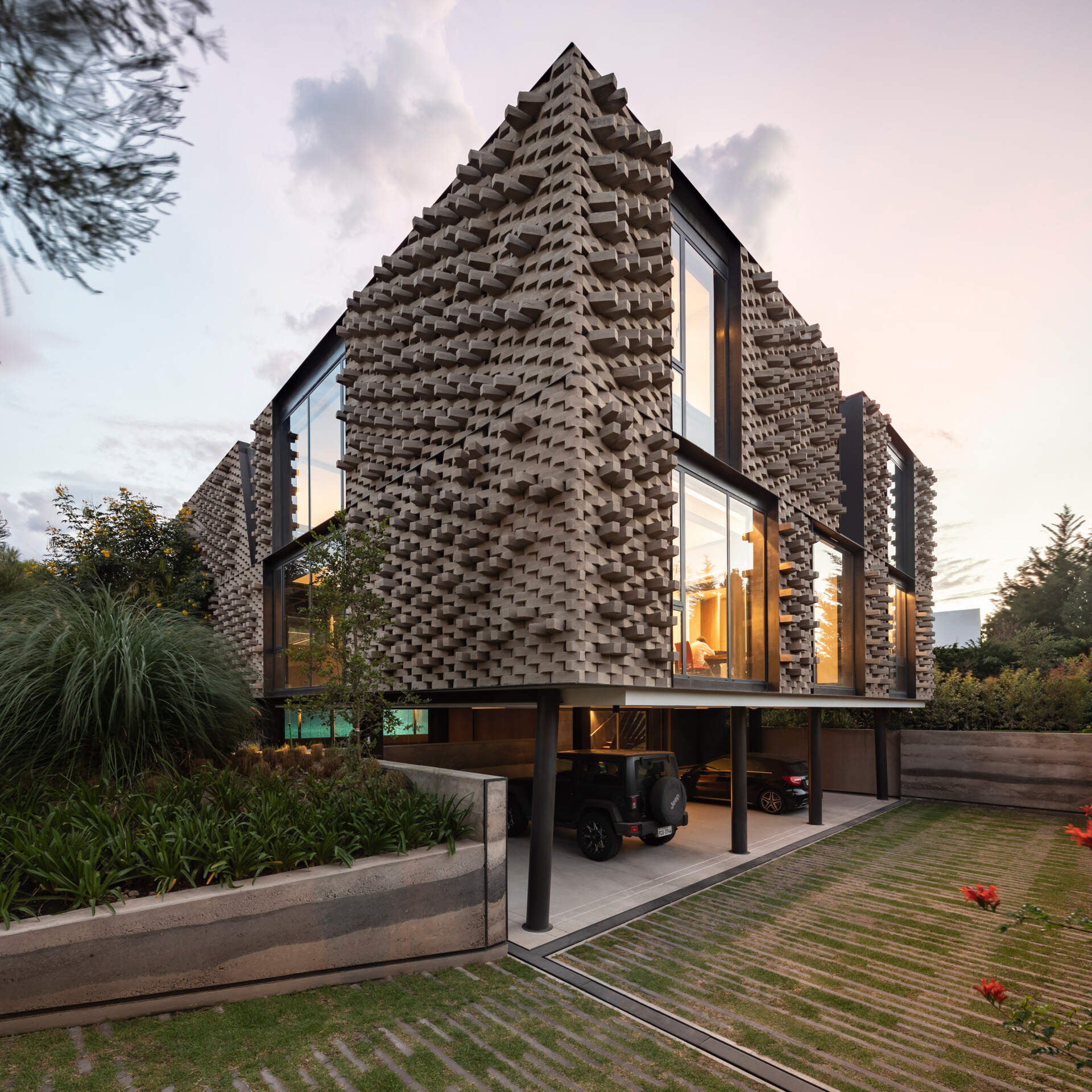 A modern home with a sculptural brick facade.