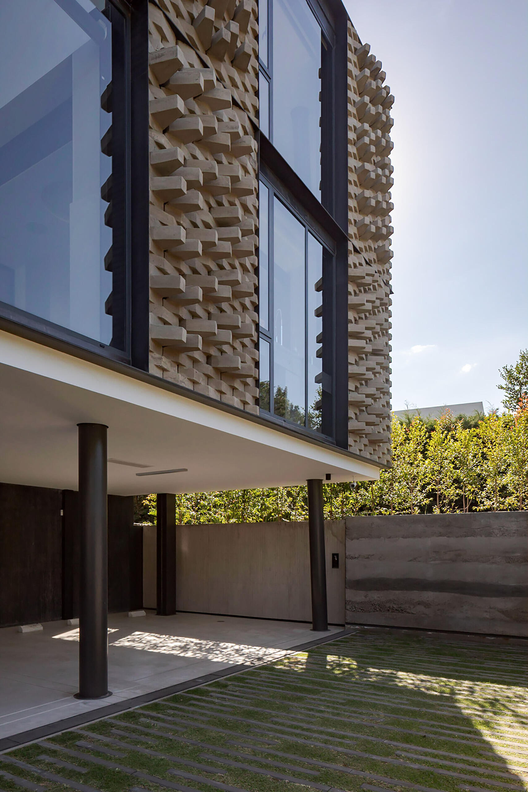 A modern home with a sculptural brick facade.