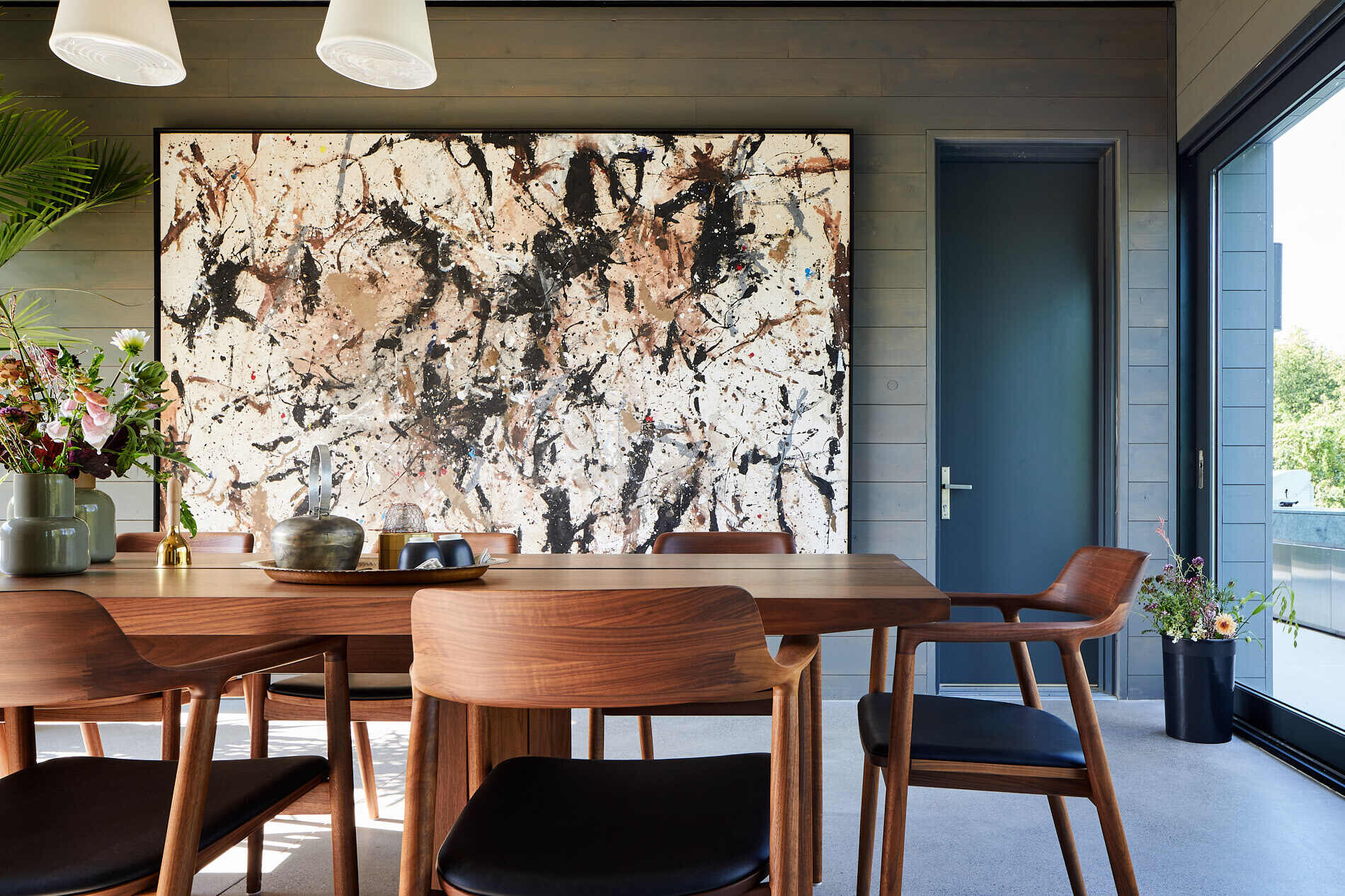 This farmhouse dining room doubles as a breezeway, seamlessly shifting between indoor elegance and outdoor airiness.