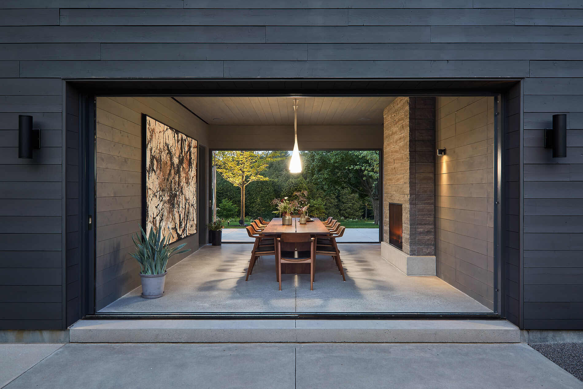 This farmhouse dining room doubles as a breezeway, seamlessly shifting between indoor elegance and outdoor airiness.
