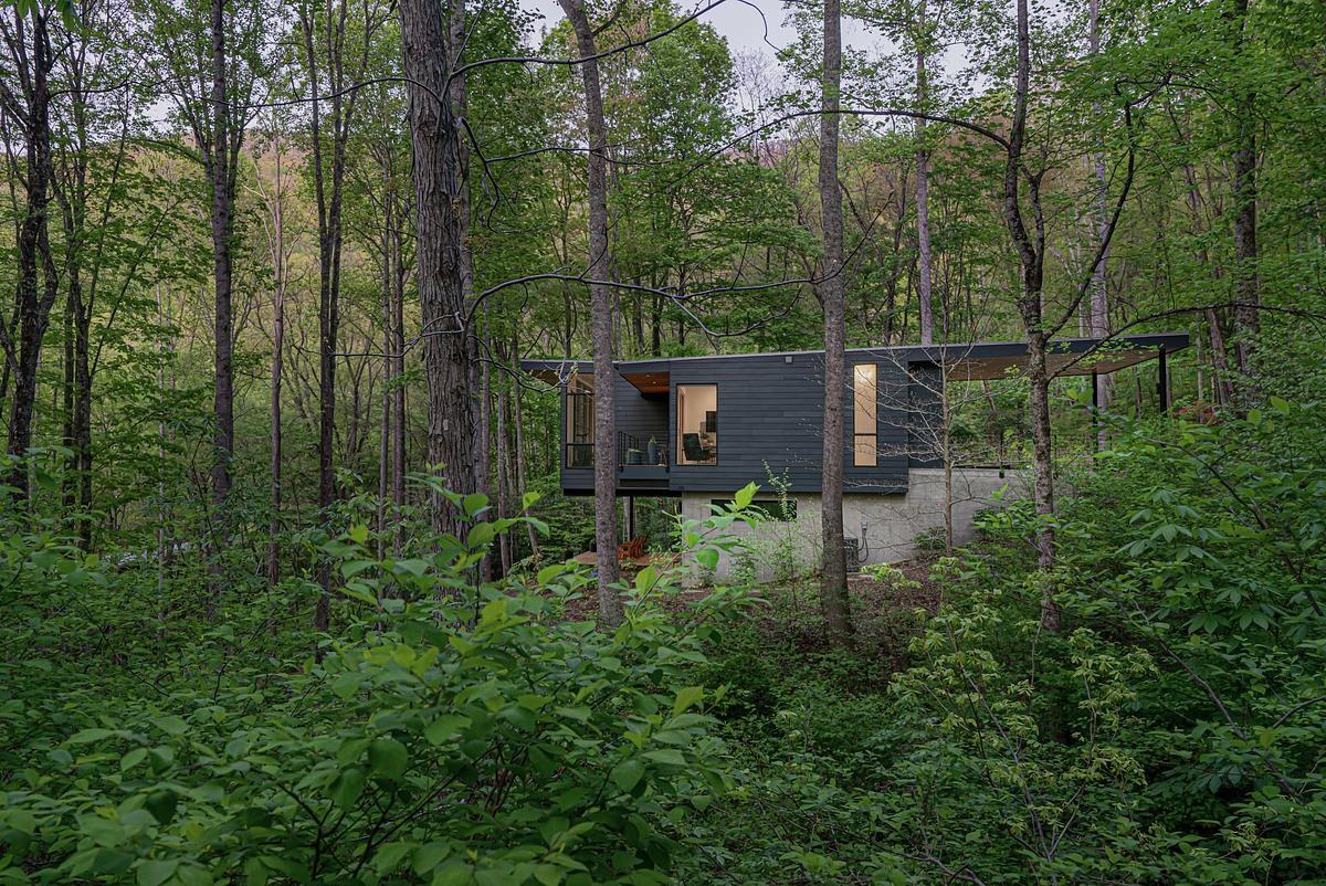 A quiet, compact home nestled in the North Carolina woods, designed to blend into the forest and open up to valley views. Thoughtful architecture meets natural beauty.