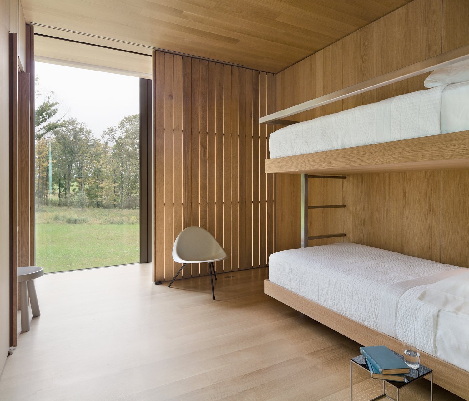 Built-in bunk bed nooks are tucked into the home’s central wood core, blending cozy sleeping space with natural light and airflow.