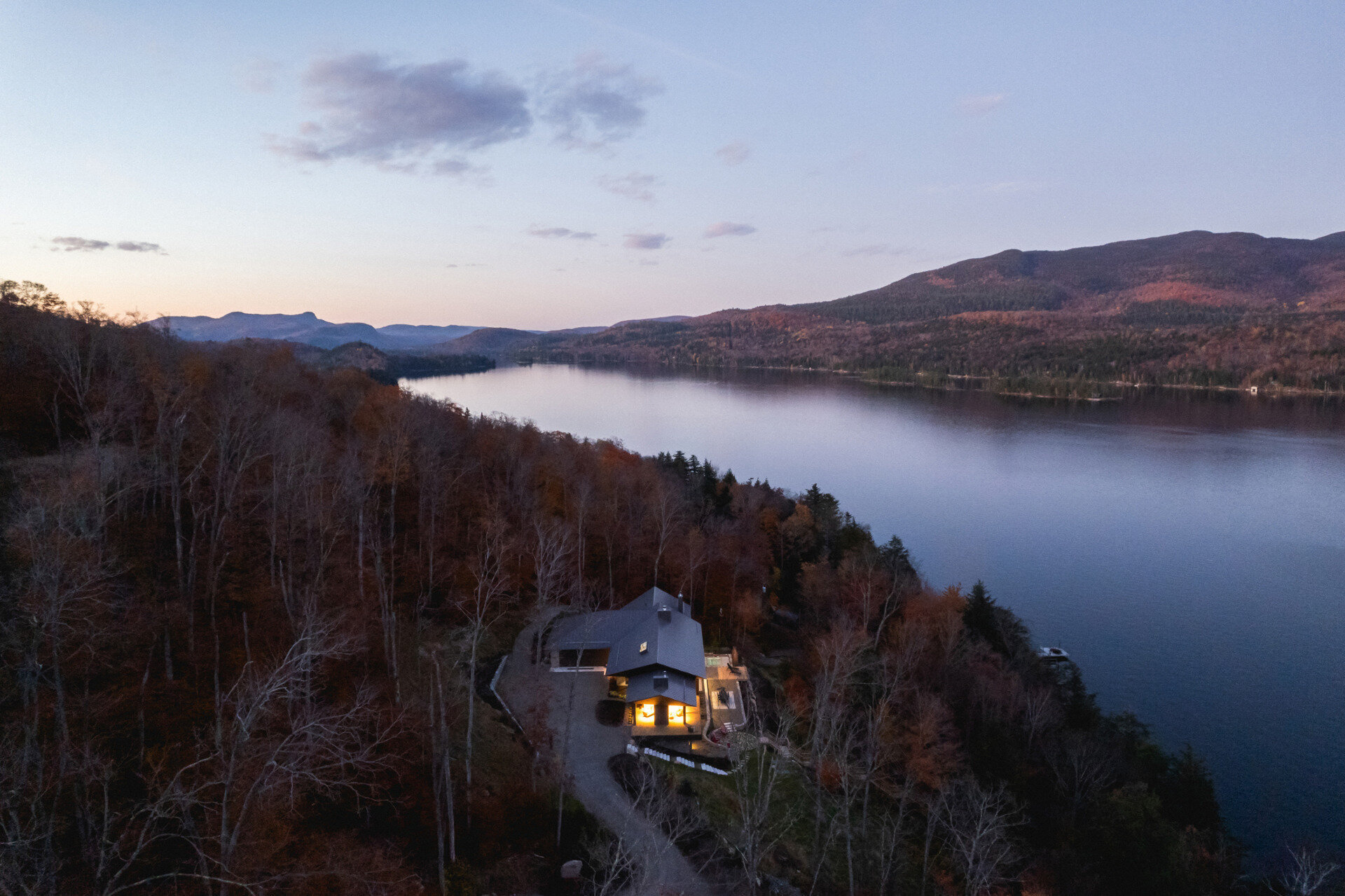 A striking modern chalet by MU Architecture, La Flèche is a forest retreat on Lake Tremblant that blends sharp rooflines, natural stone, and warm wood interiors.