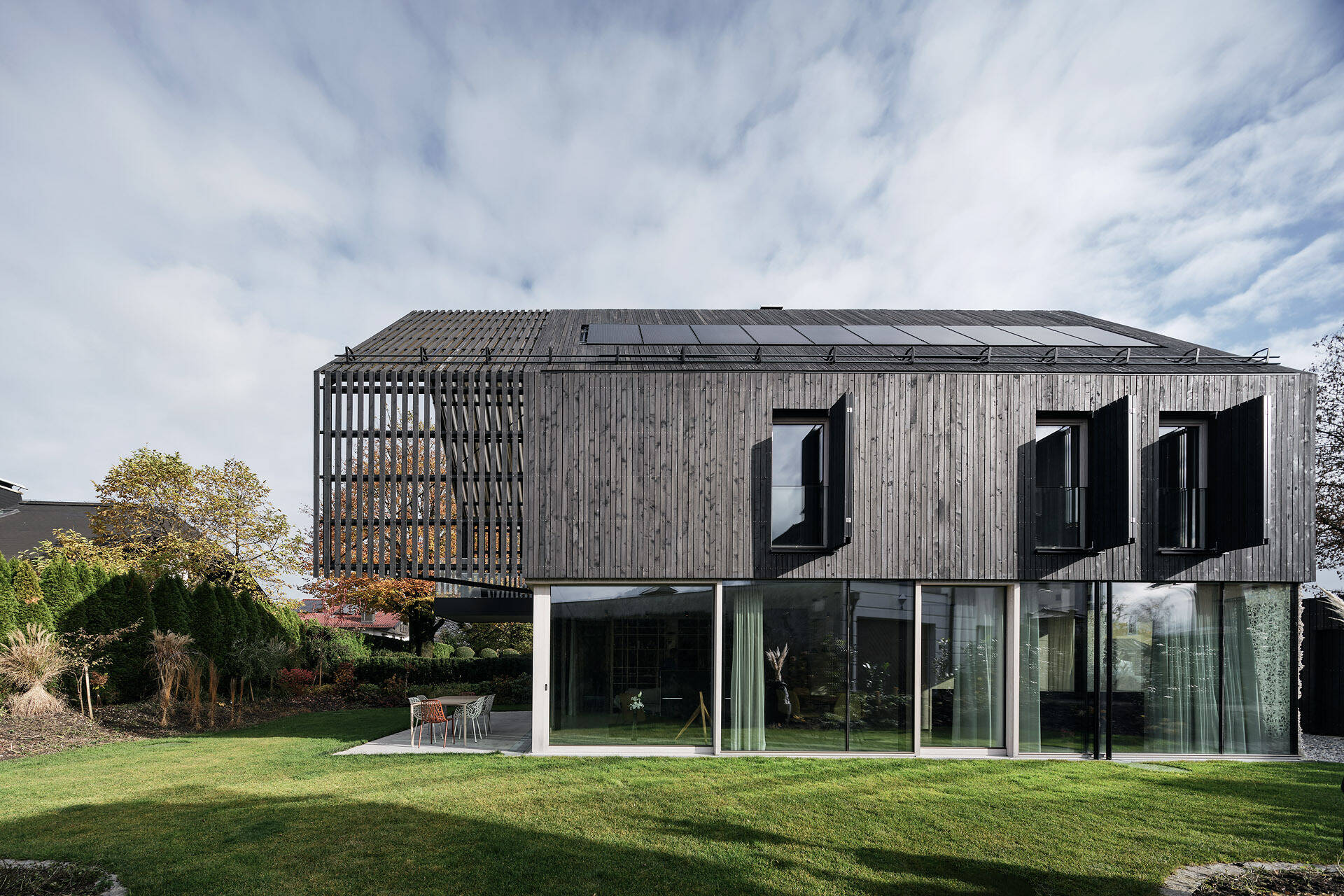 A modern gabled form wrapped in pre-weathered timber, Casa S blends tradition with a floating, sculptural silhouette.