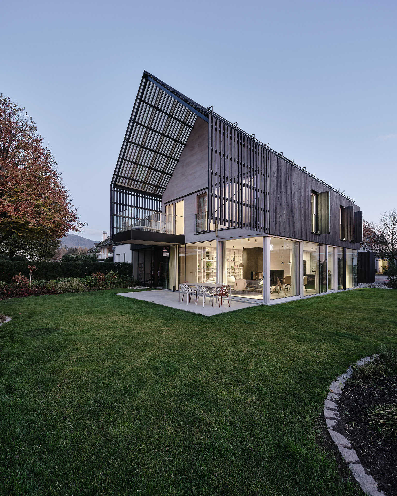 A modern gabled form wrapped in pre-weathered timber, Casa S blends tradition with a floating, sculptural silhouette.