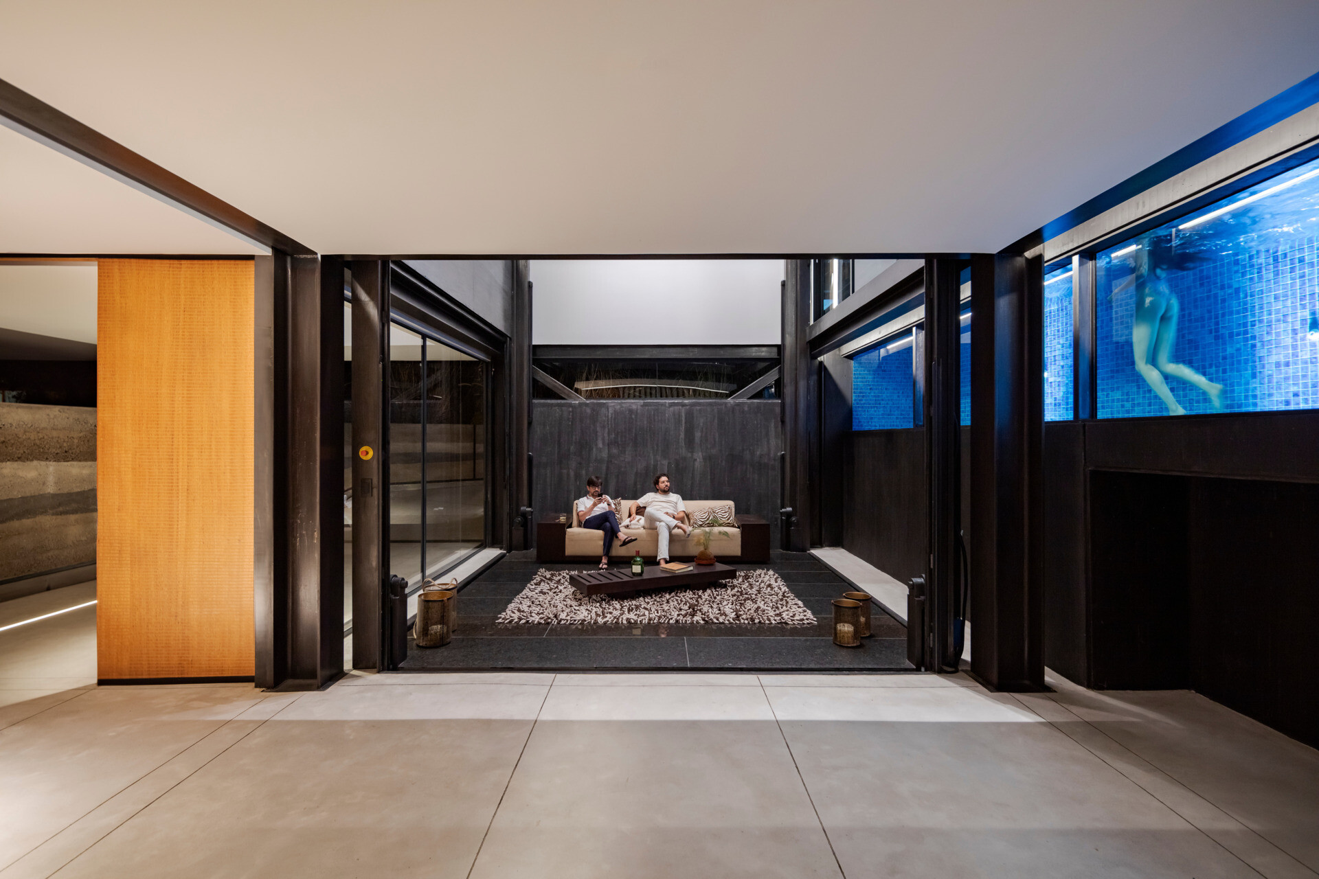 At the core of the house, a mobile elevator platform transforms how the home functions, redefining movement, program, and space with a single shifting element.