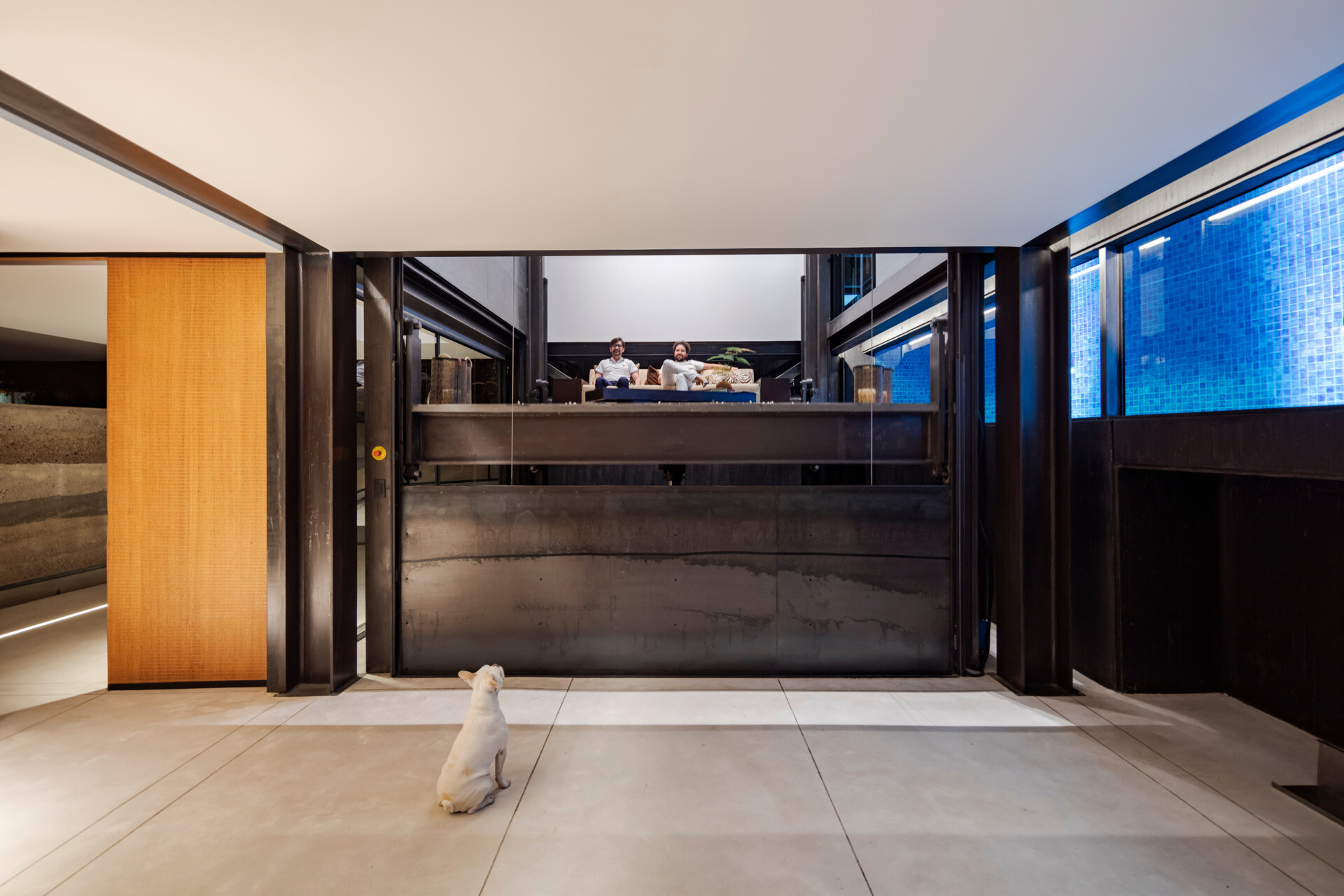 At the core of the house, a mobile elevator platform transforms how the home functions, redefining movement, program, and space with a single shifting element.