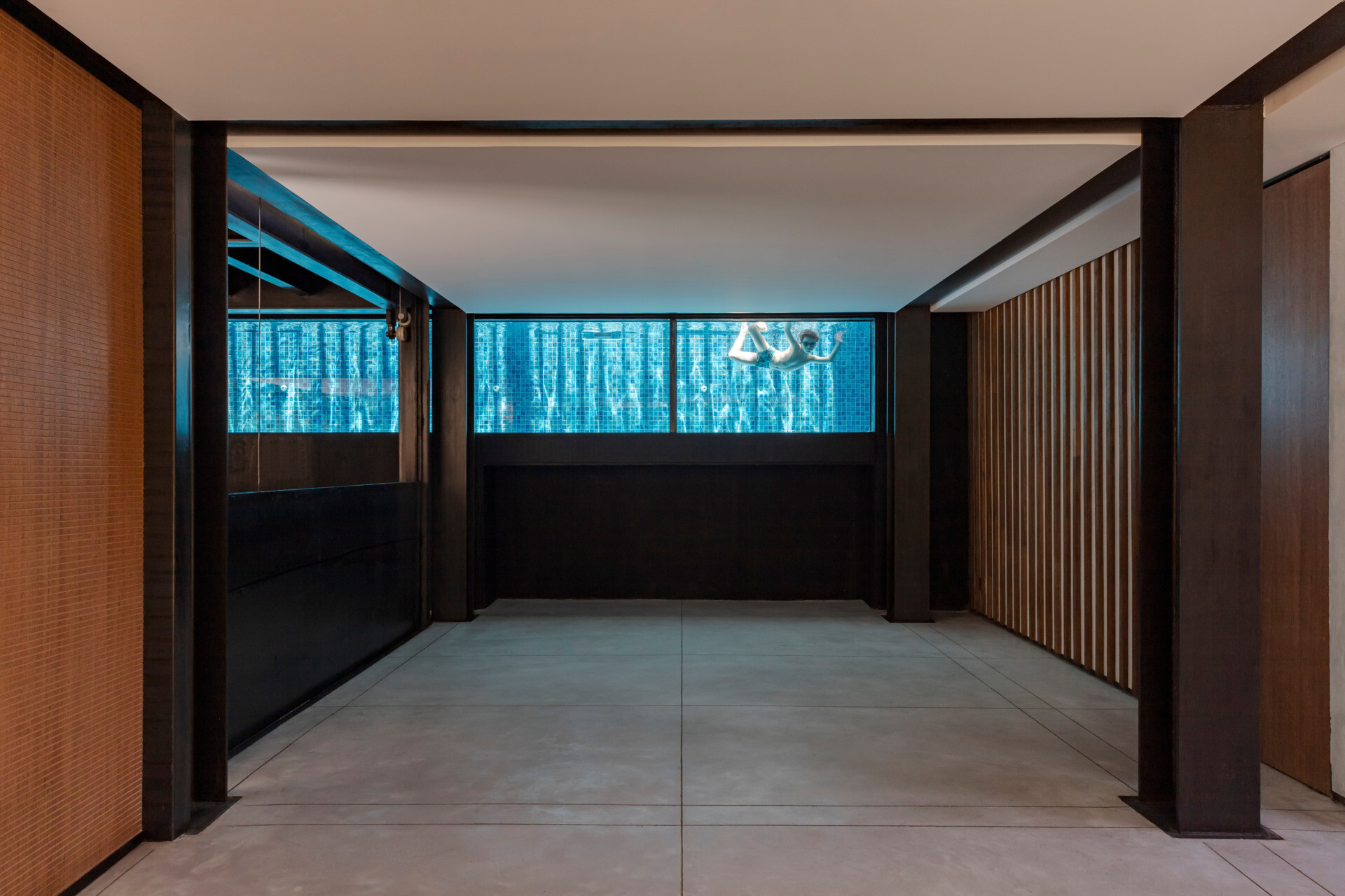 At the core of the house, a mobile elevator platform transforms how the home functions, redefining movement, program, and space with a single shifting element.