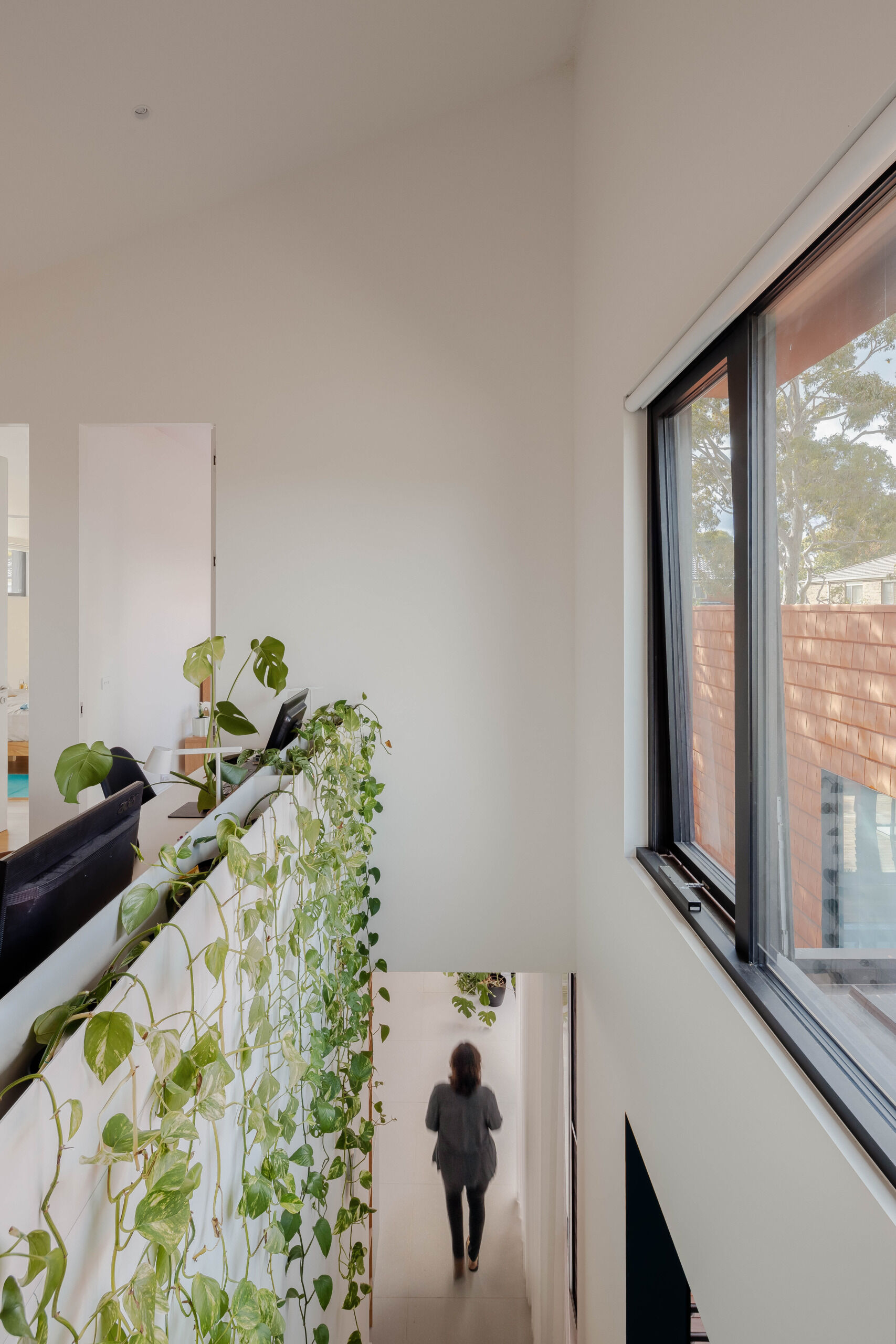 At the top of the stairs there's a home office area with built-in planters for cascading plants.