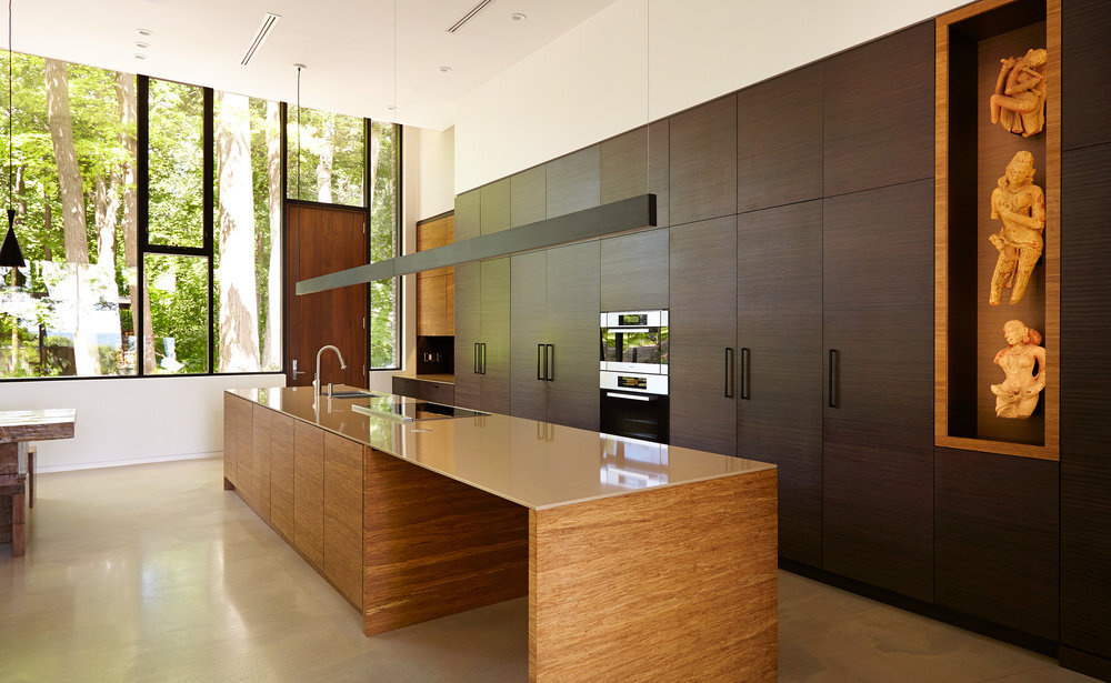 The kitchen is both functional and artistic. Ample storage is paired with a cut-out display niche, perfect for showcasing artwork from the homeowners’ collection. It's a space that balances utility with personal expression, echoing the thoughtful details found throughout the home.