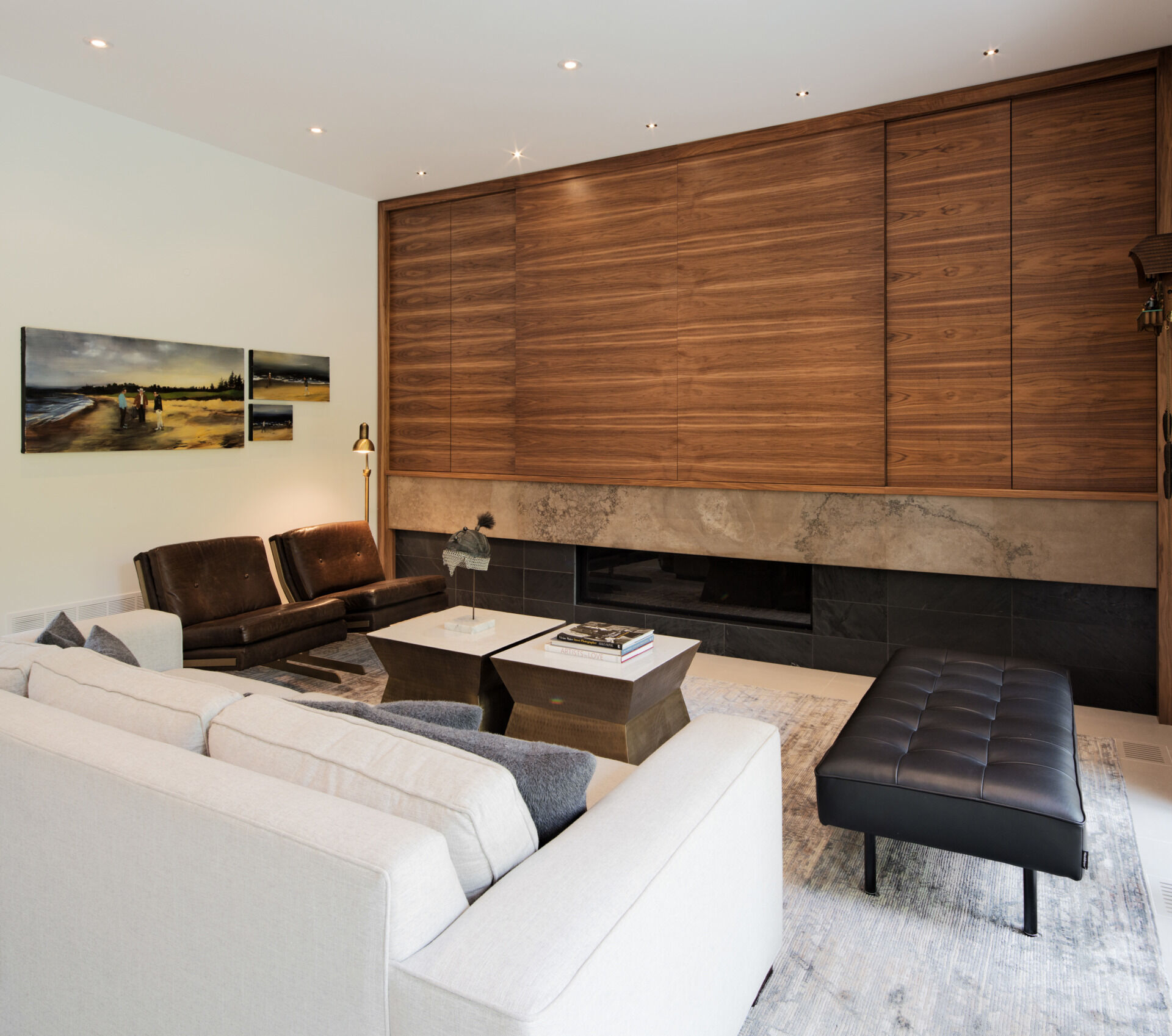 A warm wood accent wall anchors the family room in this open-concept main floor. With a wood dining table and seamless flow into the kitchen, the space feels both grounded and connected.