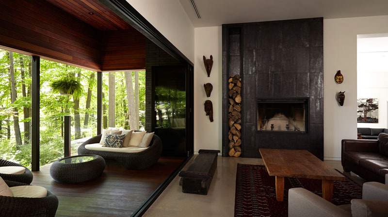 This living space brings warmth. Centered around a fireplace and finished with custom steelwork, it can expand outward when sliding doors open to the covered deck, creating a natural flow between indoors and out.