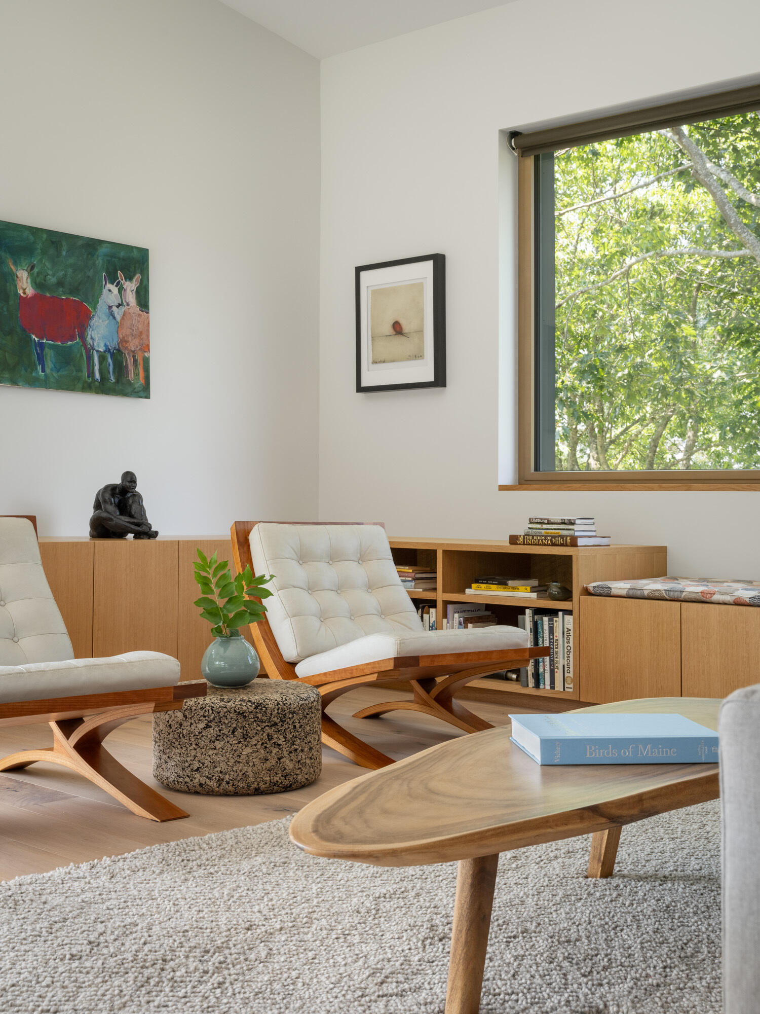 Bright white oak floors and triple-glazed windows create a warm, light-filled living room with ever-changing views of the Bagaduce River.