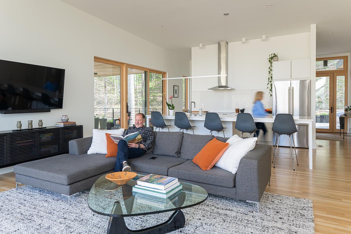 A modern plan interior with the living room and kitchen sharing the space.