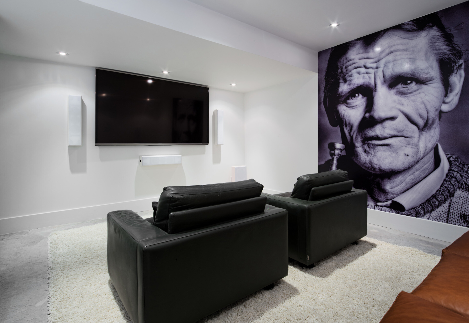 A cozy media room offers a private space for relaxation and entertainment, balancing the open main living areas with casual comfort and quiet retreat.