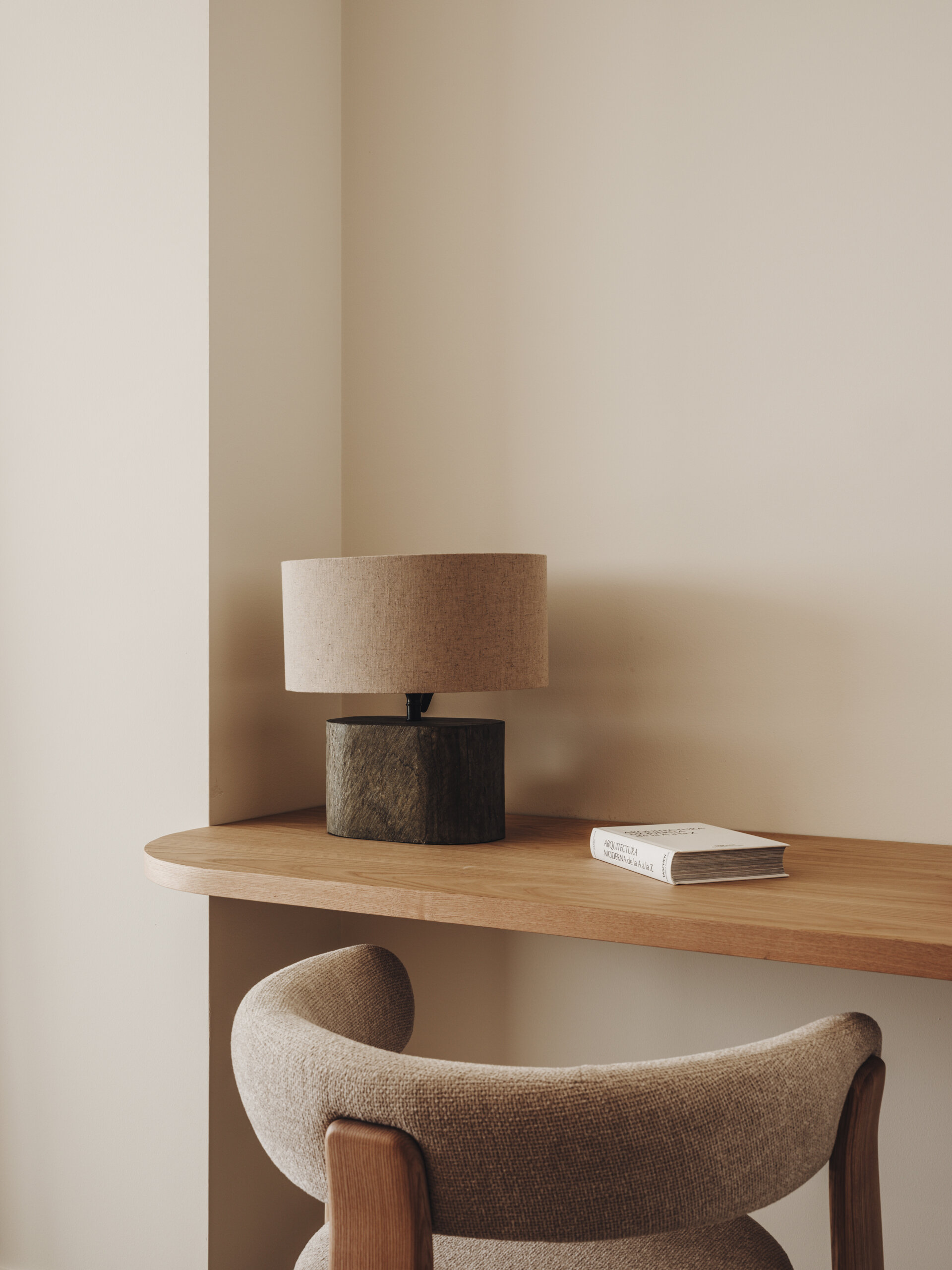A serene upper-floor bedroom retreat where oak and travertine combine with filtered light and horizon-facing views.