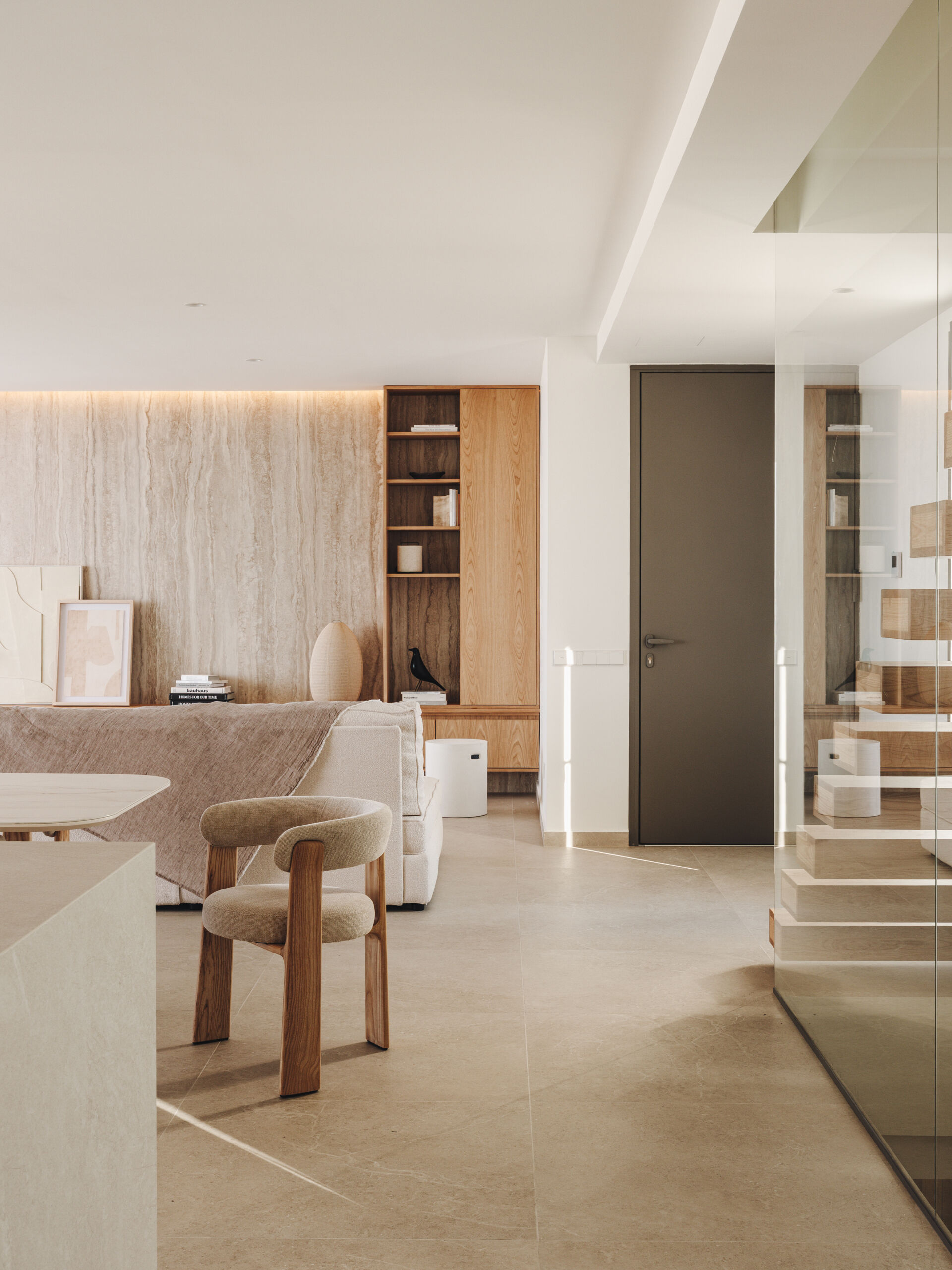 Floating oak treads enclosed in glass turn this stairwell into a sculptural element at the heart of the home.