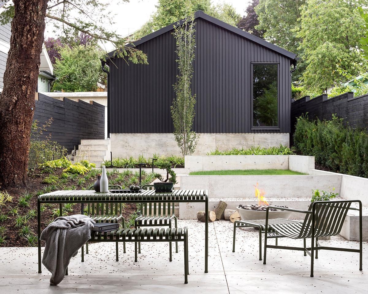 A terraced backyard and covered rear deck extend the living space outdoors, with sliding glass doors creating a seamless connection between inside and out.