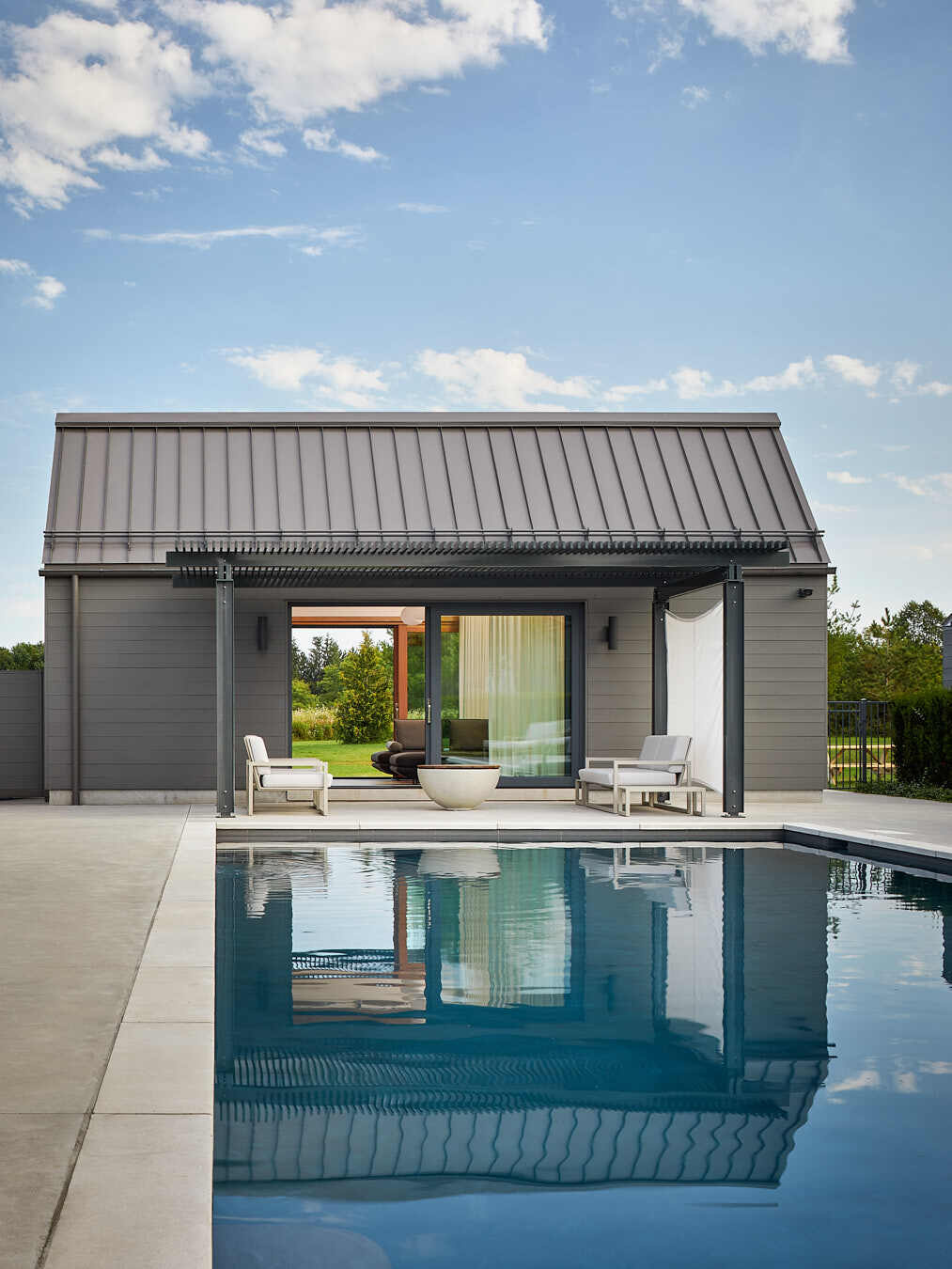 A pool and guest house sit alongside a charming cabana, ideal for slow summer days and starry nights.