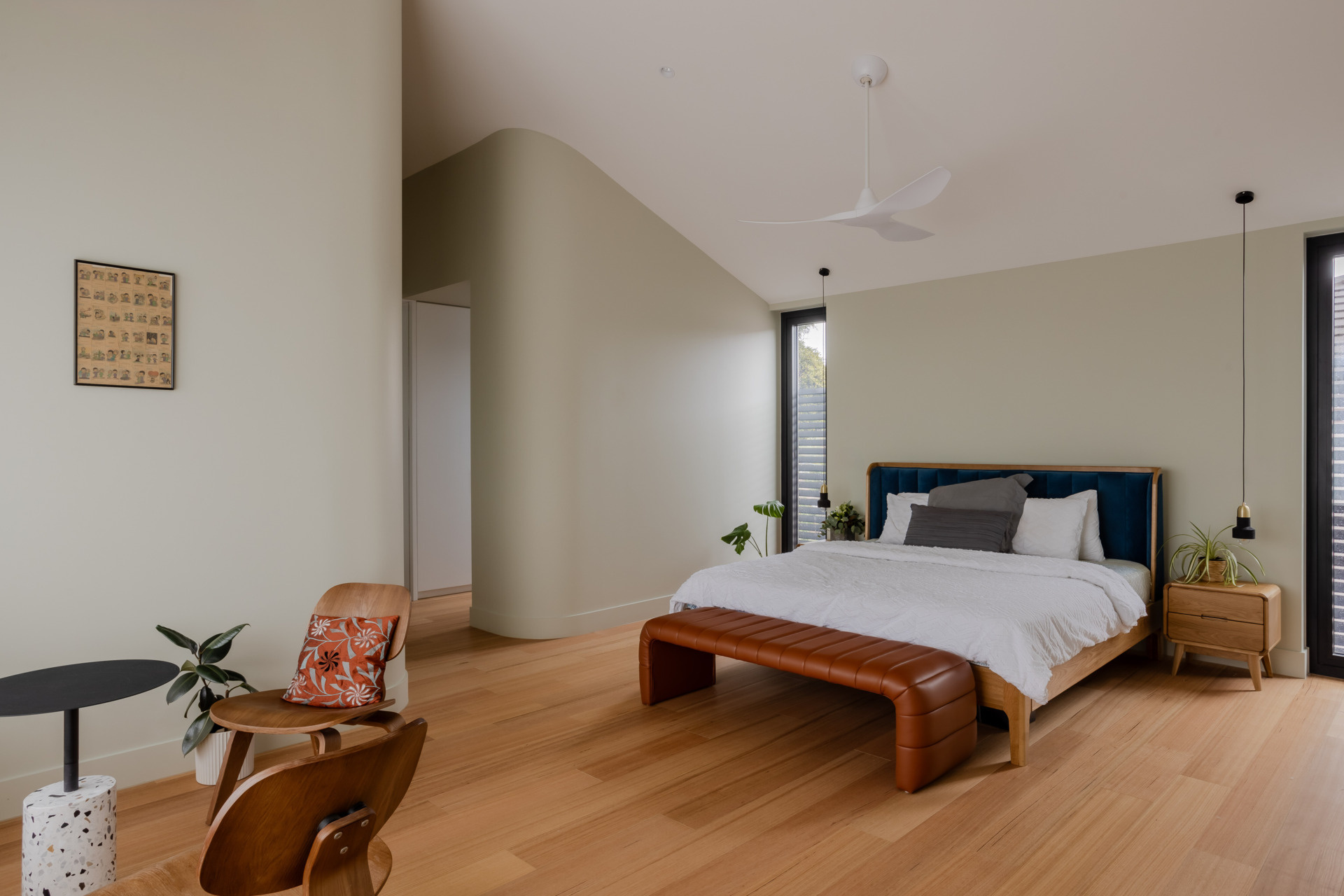 Positioned for privacy and outlook, the primary bedroom for the parents, is a restful space with leafy views. Its palette is subdued but warm, echoing the natural tones found throughout the rest of the home. A built-in bench runs along the window, offering a quiet place to pause. Every detail has been considered to promote calm and comfort.