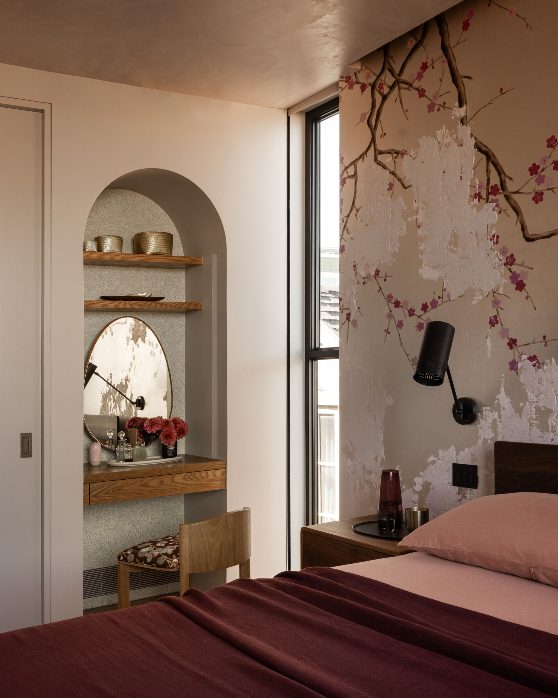 A built-in vanity wrapped in Zak & Fox wallcoverings is paired with a sculptural Nickey Kehoe stool. It’s a quiet, elegant detail that blends seamlessly into the room’s overall calm and refined atmosphere.
