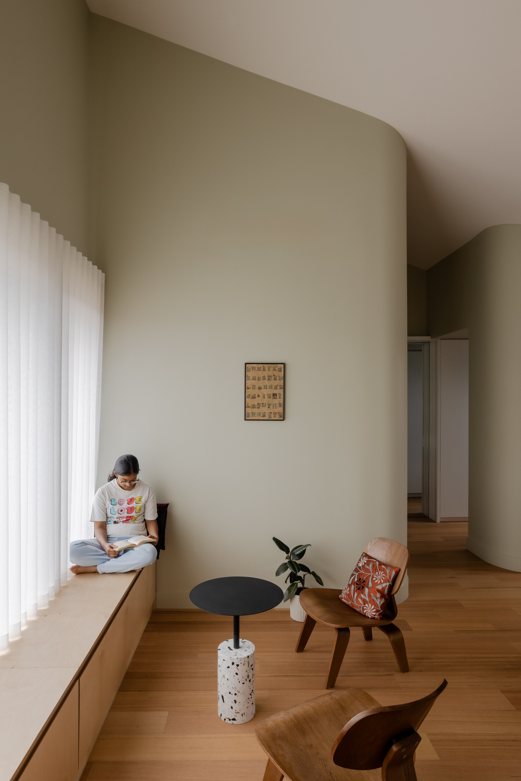 Positioned for privacy and outlook, the primary bedroom for the parents, is a restful space with leafy views. Its palette is subdued but warm, echoing the natural tones found throughout the rest of the home. A built-in bench runs along the window, offering a quiet place to pause. Every detail has been considered to promote calm and comfort.