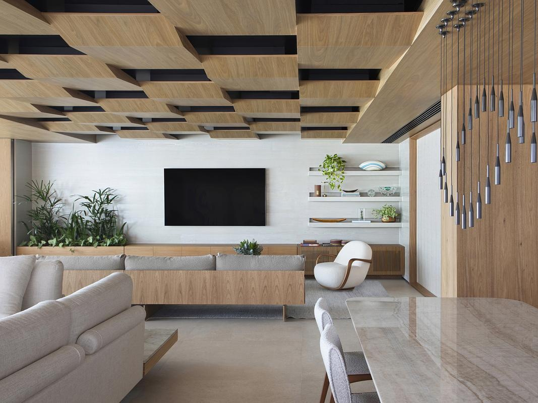 This geometric wood ceiling in an open plan interior transforms structural necessity into a standout design feature, blending texture with hidden functionality.