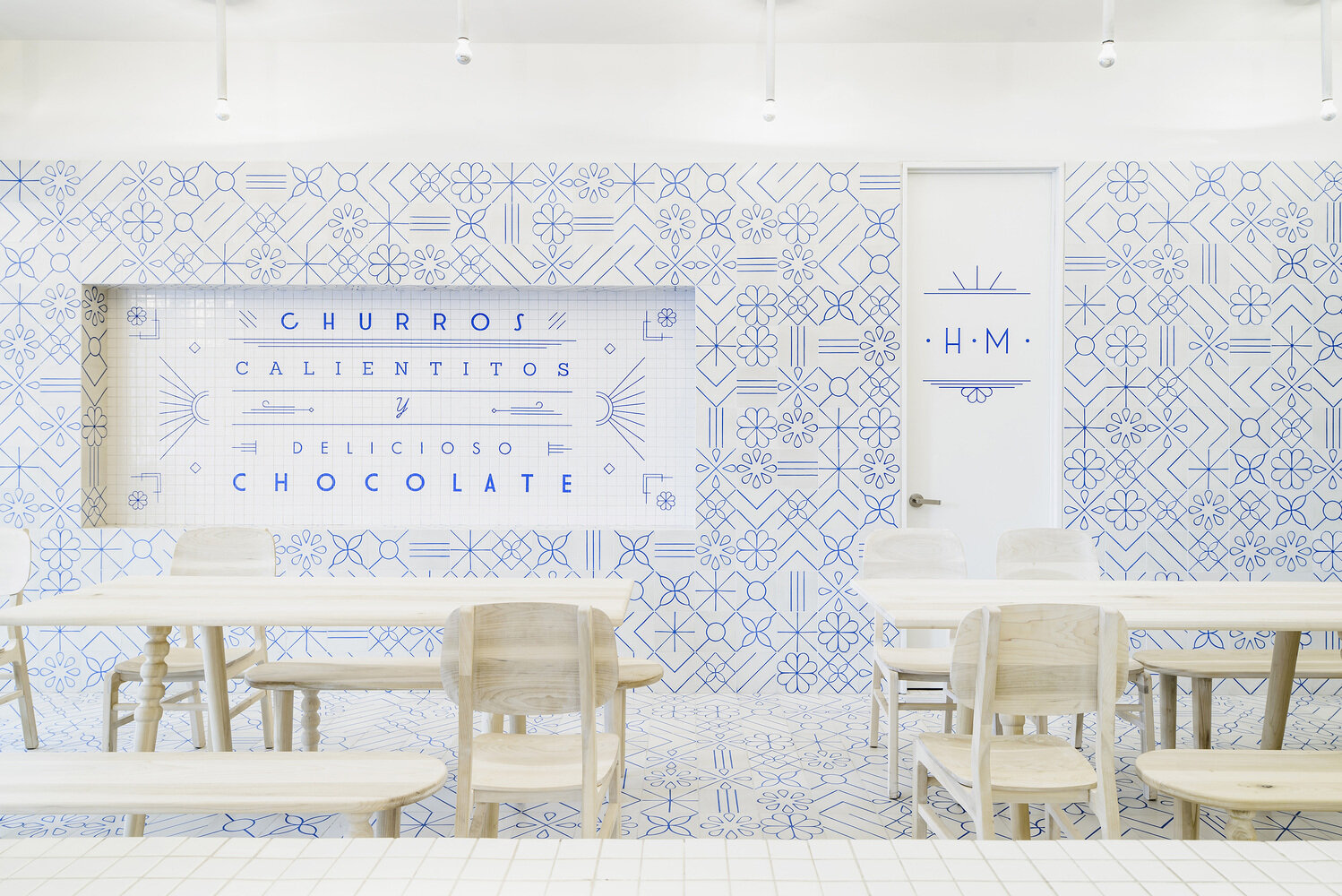 Step inside EL MORO, a historic Mexico City café reimagined with playful blue-and-white tilework, Art Deco touches, and a minimalist palette inspired by sugar and tradition.