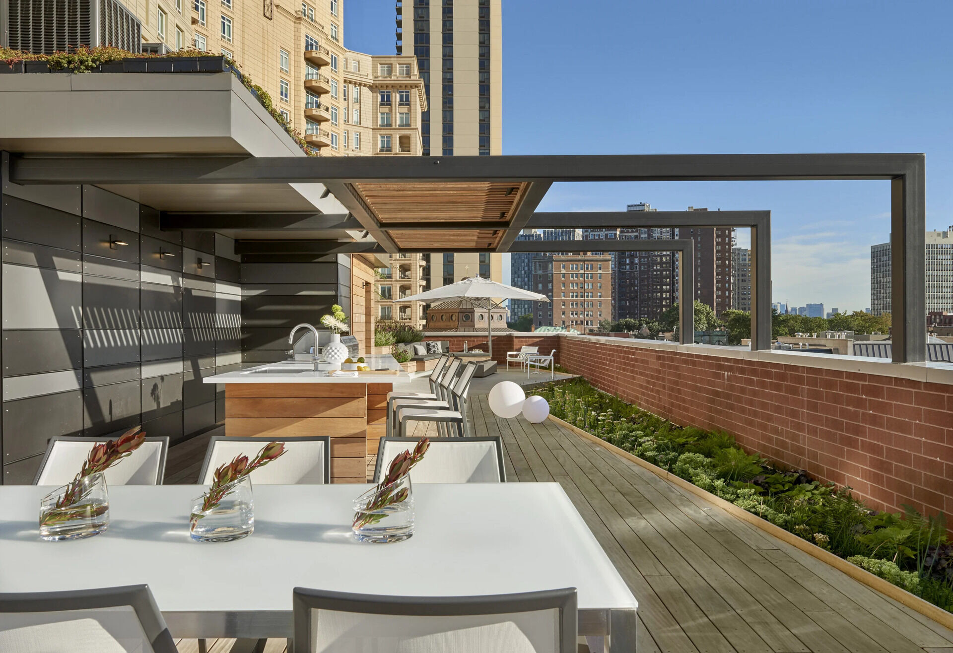 Terraced hardwood steps and porcelain tile define outdoor rooms in this rooftop retreat, creating the feel of a private yard high above the city.