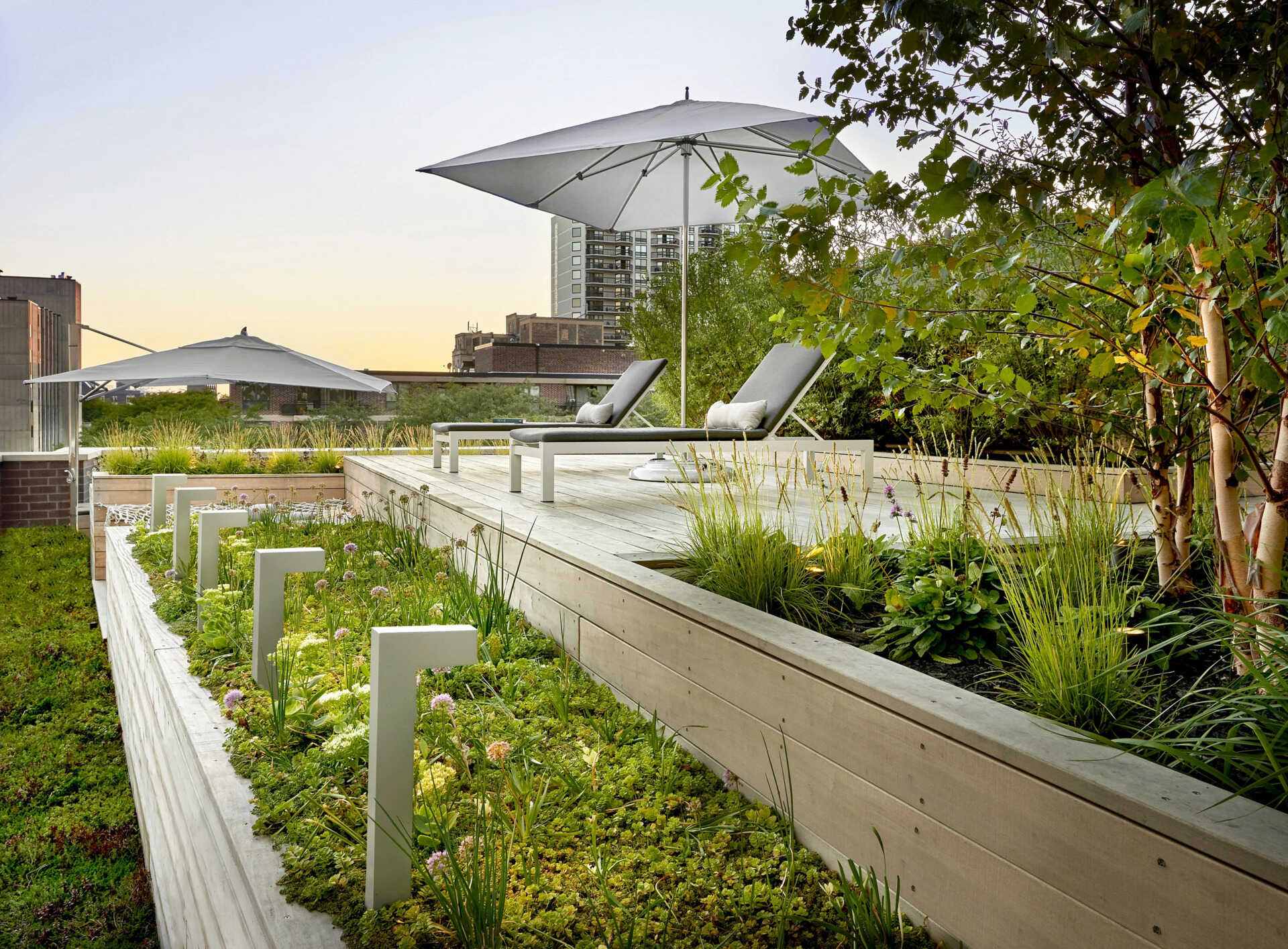 Terraced hardwood steps and porcelain tile define outdoor rooms in this rooftop retreat, creating the feel of a private yard high above the city.