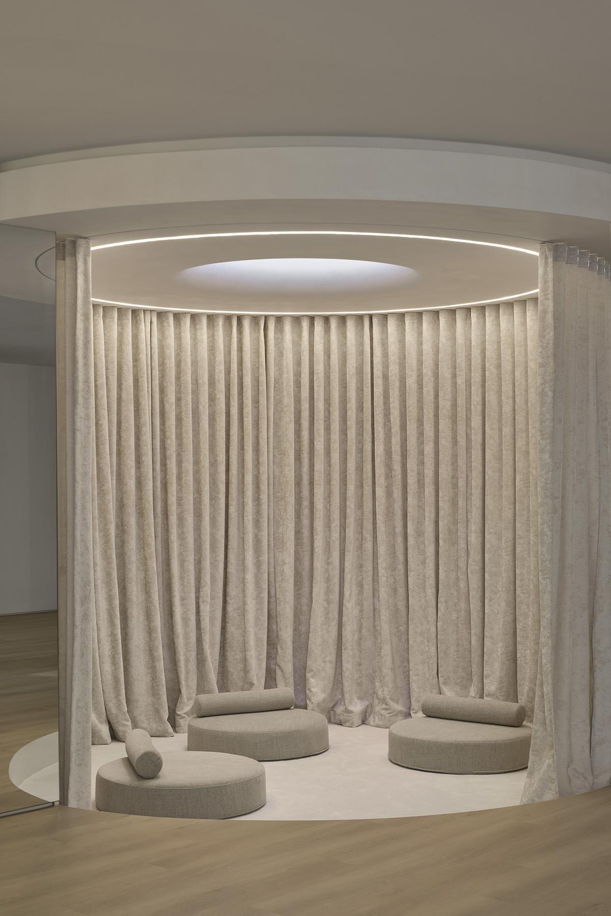 Tucked within the wellness level of a modern home, this circular sitting area offers a moment of retreat.