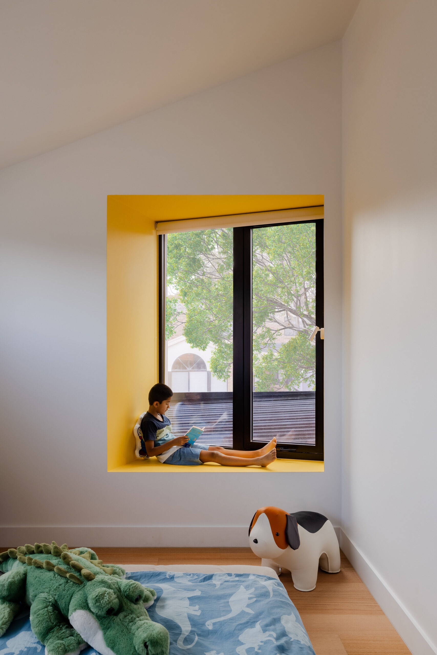 Just like the rest of the home, this boys’ bedroom balances function with personality. It’s a space for rest, play, and growth, with thoughtful touches like a brightly painted yellow window bench.