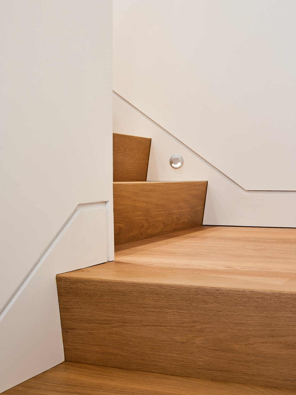 A simple staircase leads to a light-filled loft studio above the garage, a serene spot for work, rest, or reflection.