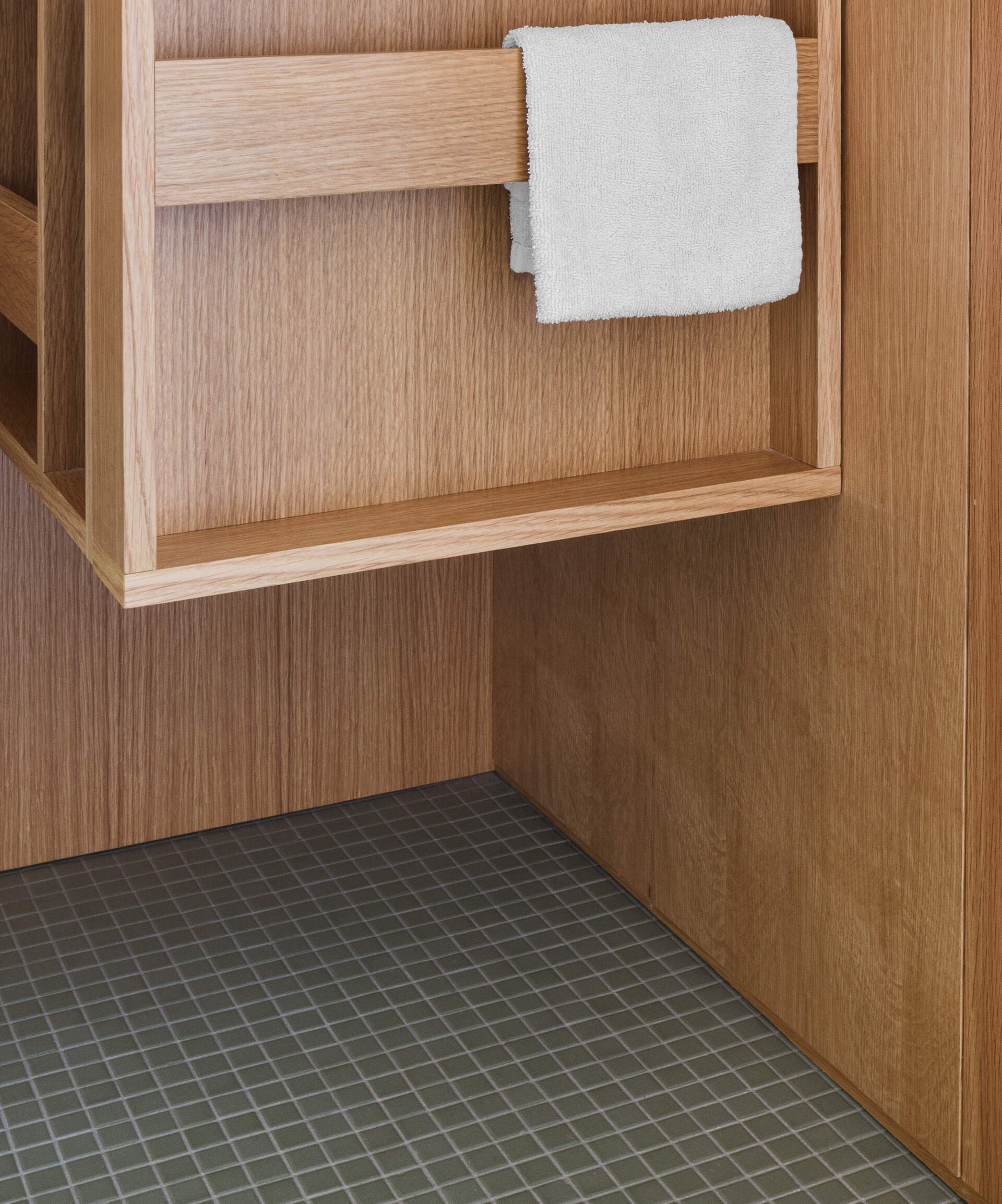Tucked into a white oak insert, this powder room proves small spaces can still make a statement with thoughtful finishes and seamless integration.