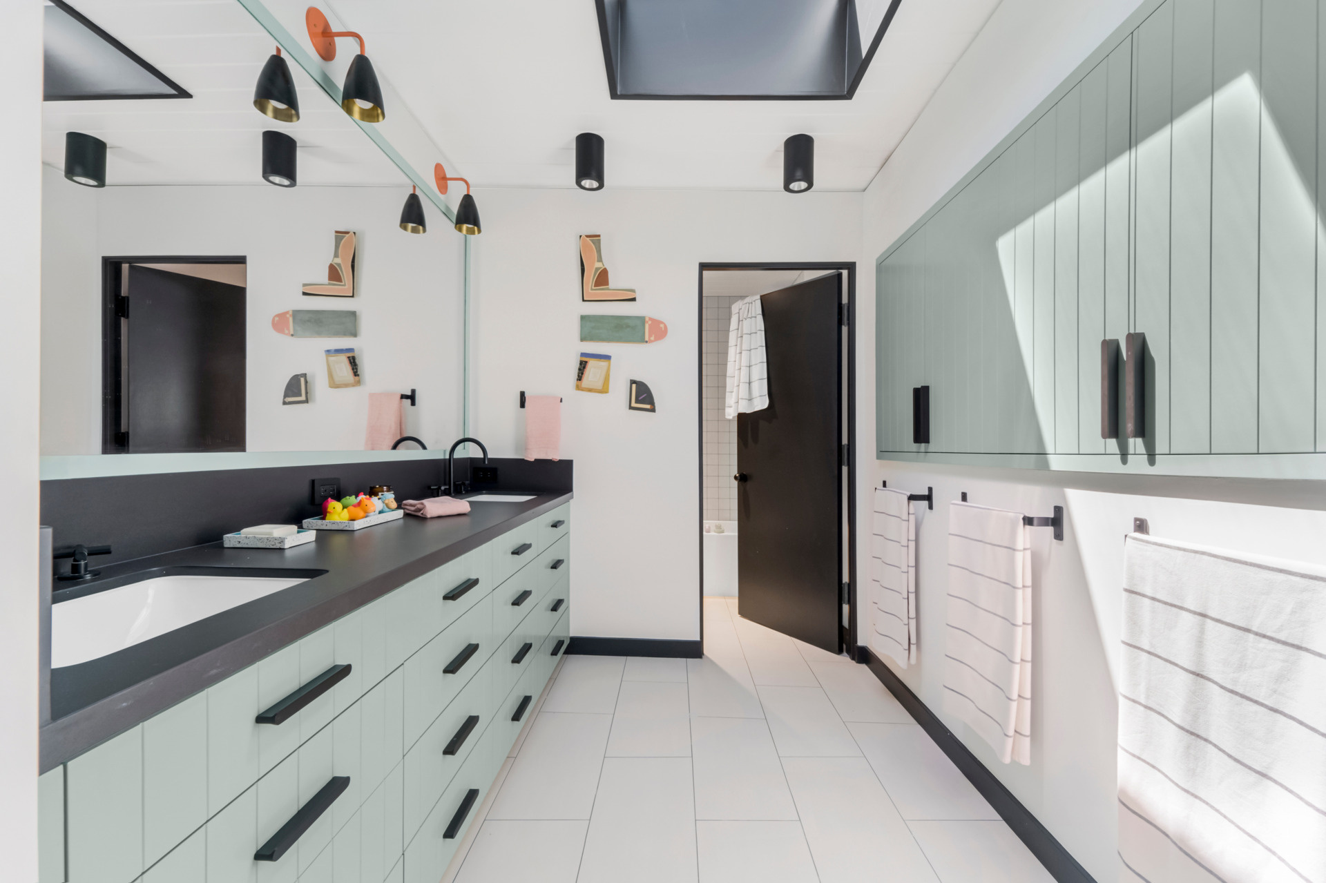 The children’s bathroom benefits from a new light well that brings daylight deep into the space. A custom vanity and cabinetry by Gustave Carlson keep the space functional, yet elevated.