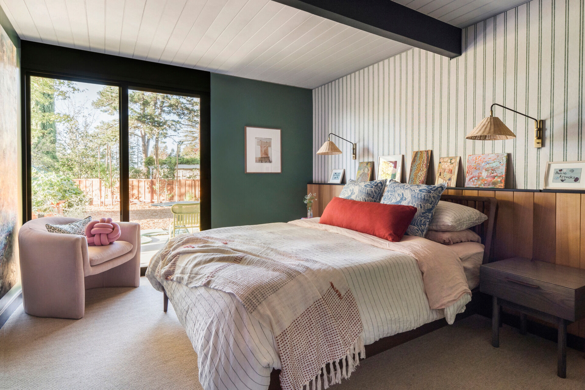 The guest bedroom has an art ledge in Western Red Cedar, stained to reveal the wood’s natural grain. It’s a subtle, repeating gesture that unifies rooms across the home.