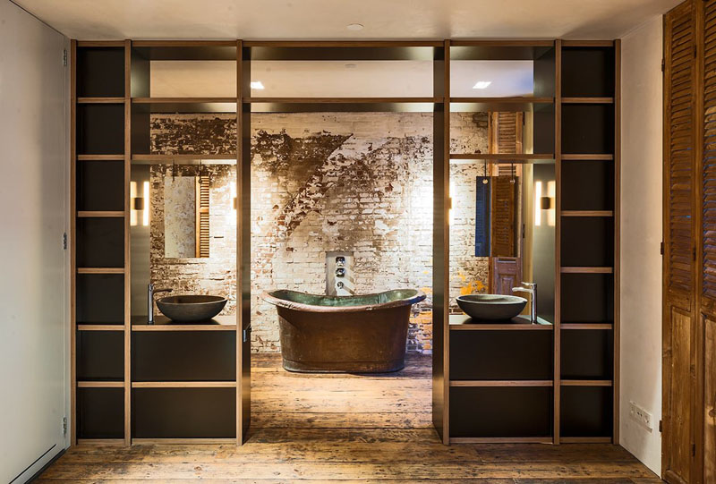 Exposed original brick makes a bold feature in this serene ensuite, offering texture and a timeless link to the home’s past.