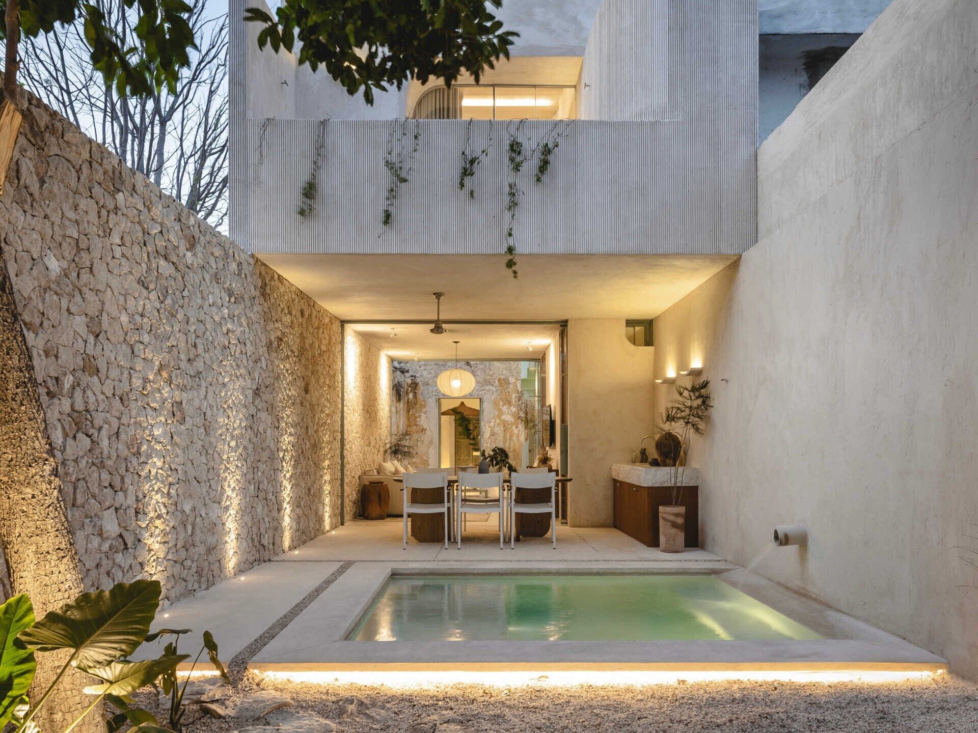 This renovated home sits on a narrow urban lot just five meters wide and over 30 meters long, and has six modules with three enclosed spaces and three open-air patios.