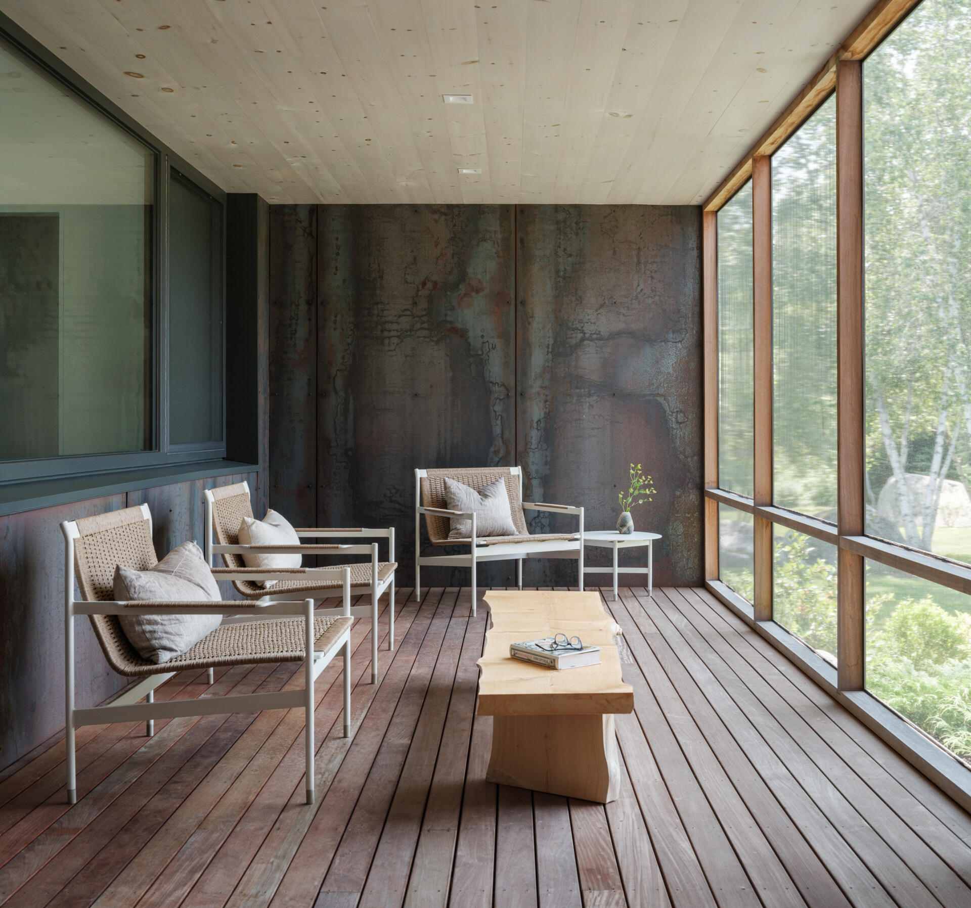 This screened porch connects the workshop to the main home, and offers views of both the entry path and the river beyond. Designed for lingering.