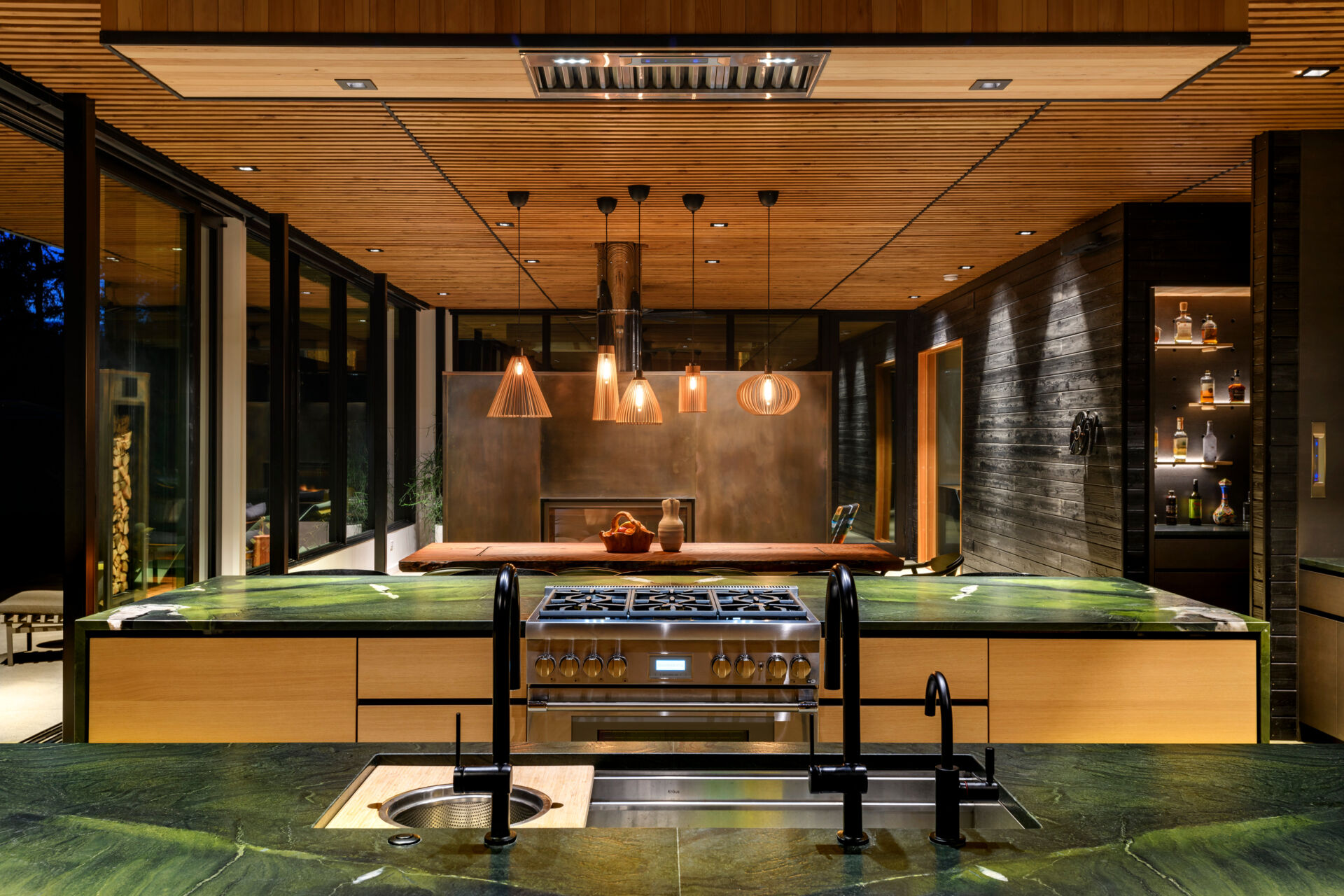 An open plan kitchen with two islands and skylights, is built for gathering, with clean lines, ample light, and strong indoor-outdoor flow.