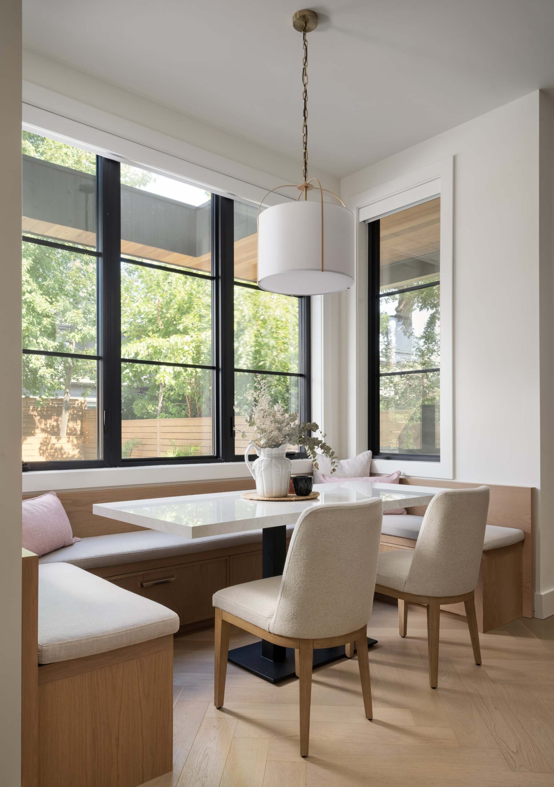 This breakfast nook is a custom-built niche surrounded by windows. The layout encourages conversation, while the built-in seating hides storage.