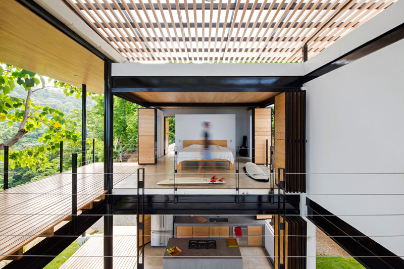 A modern bedroom that opens to the terraces of the home.