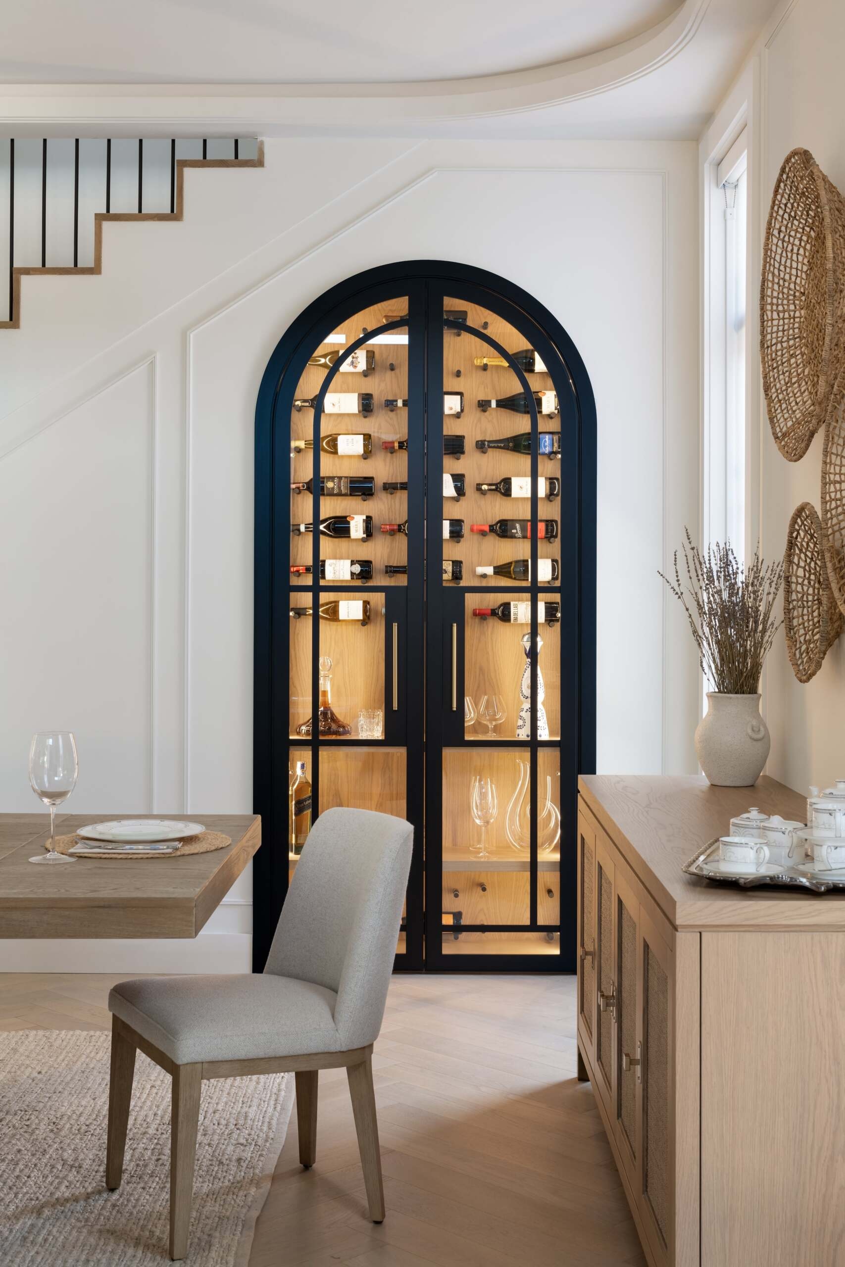 This dining area carries an atmosphere of quiet elegance, designed to complement the living space. Thoughtful proportions and material choices create a refined backdrop for family meals, while integrated wine storage adds a practical yet stylish touch.